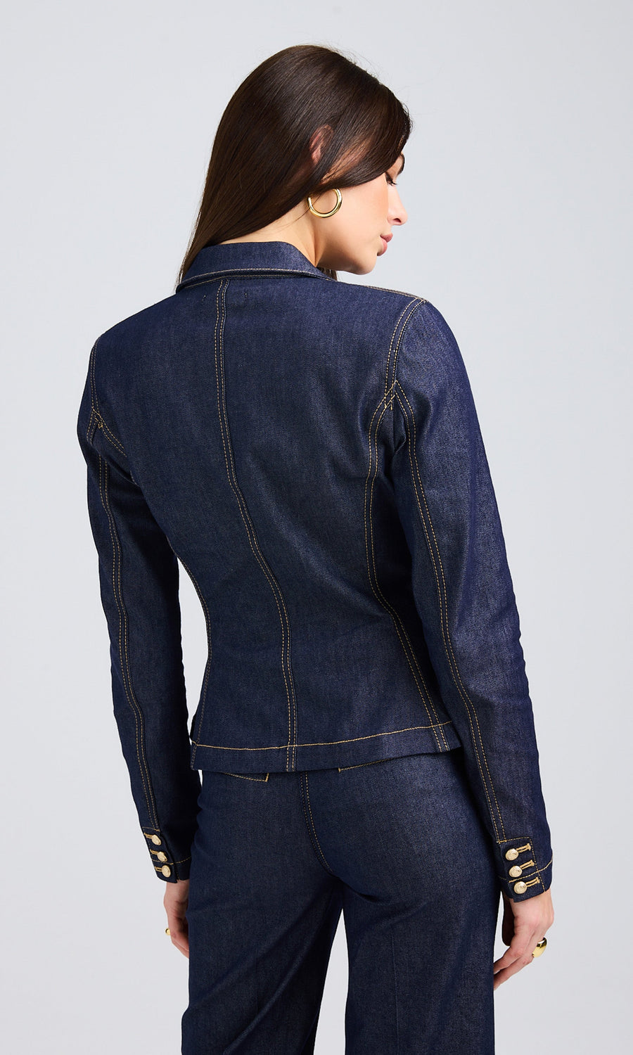 Close-up of a woman wearing a dark blue denim jacket with a sleek, tailored fit.