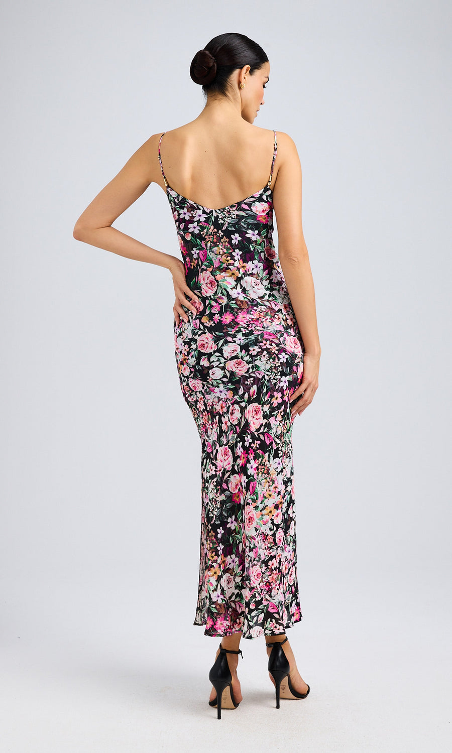 Rear view of the model in the floral midi dress, showcasing the flattering fit and flowy fabric.