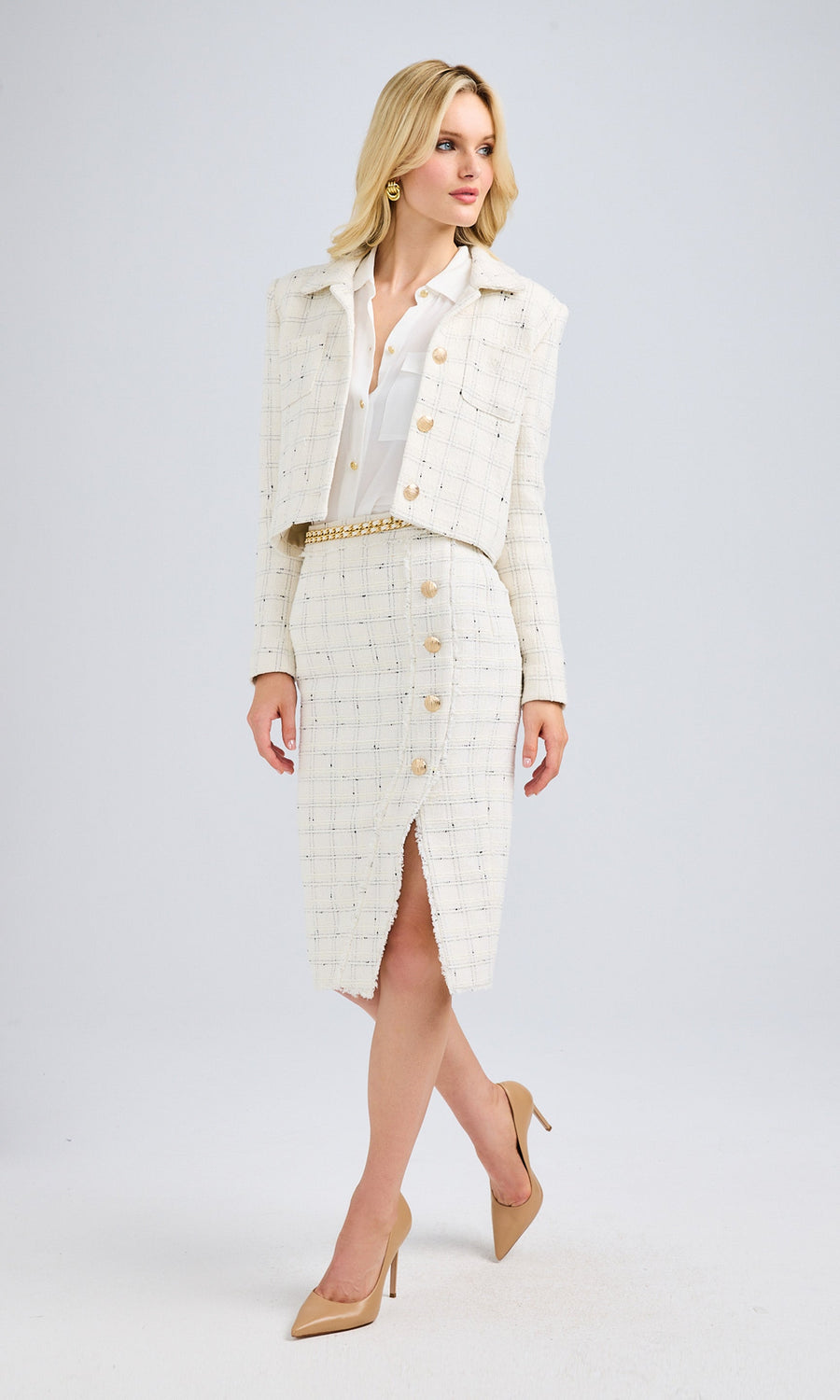 Full-body view of the model in the white tweed cropped jacket and matching skirt, highlighting the elegant ensemble.