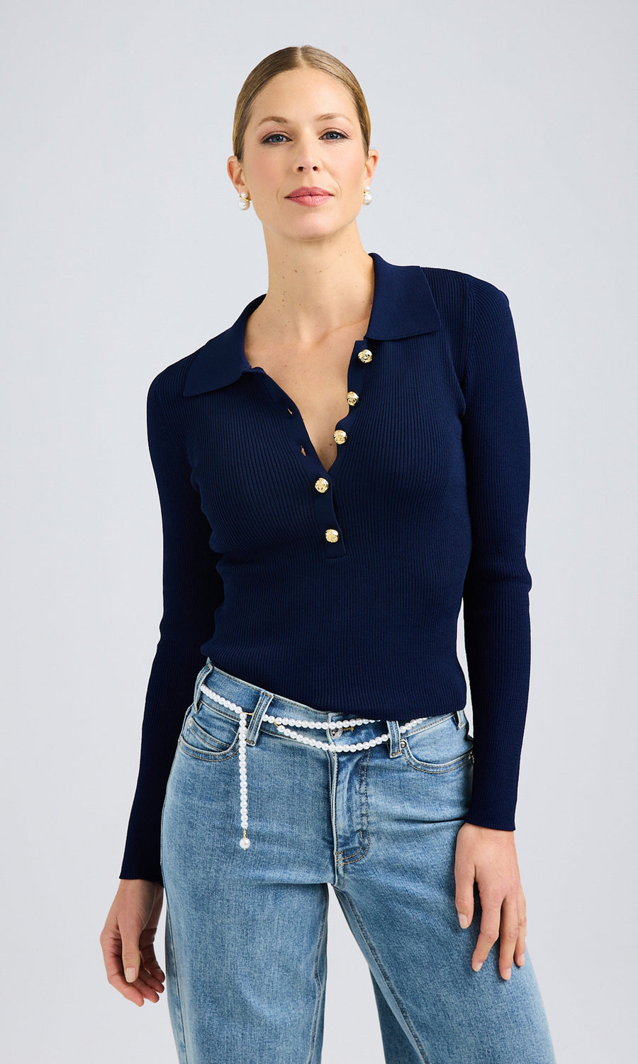 Model wearing a navy blue Viviana Sweater with jeans, presenting a trendy and relaxed look.