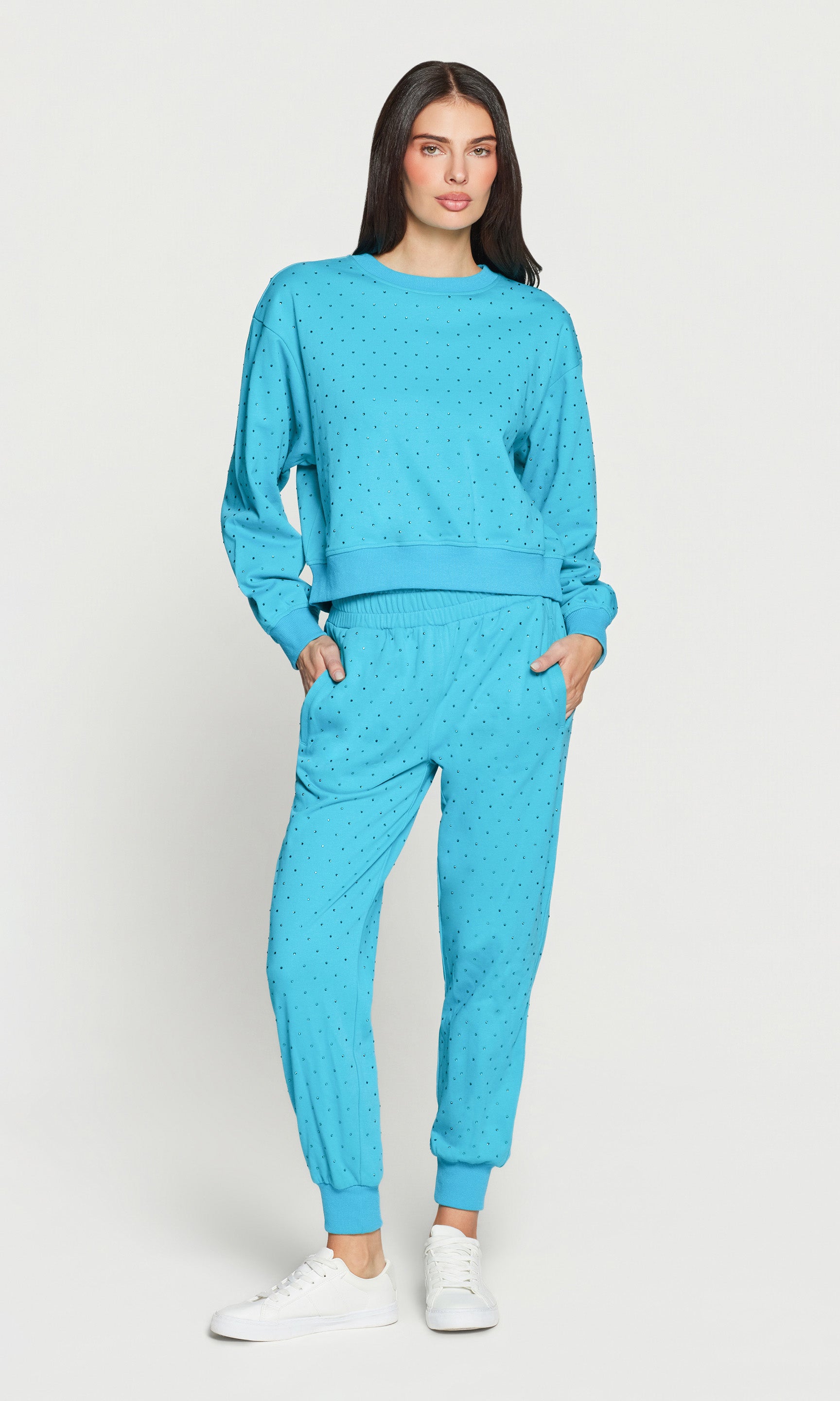 Woman wearing a blue tracksuit on a white background