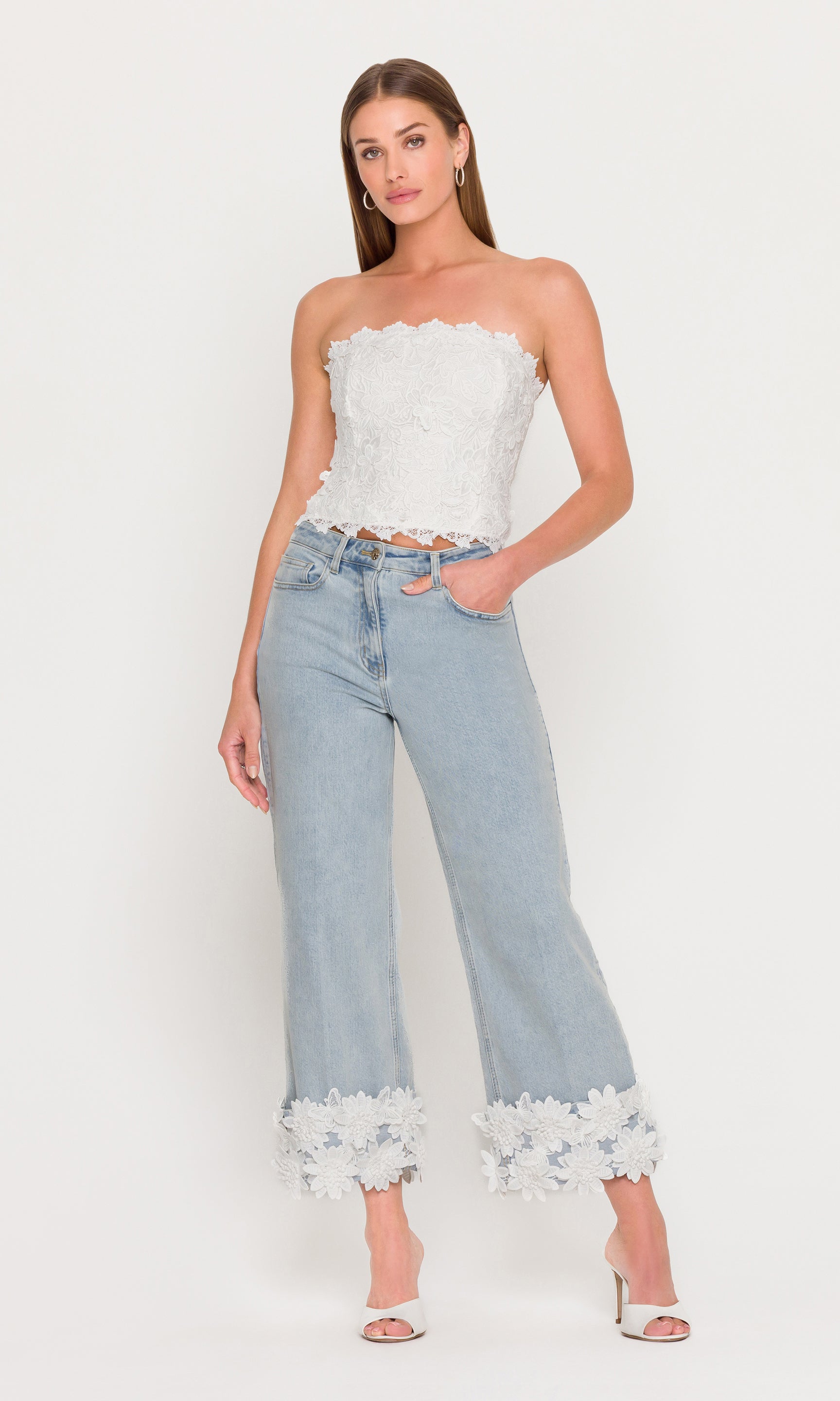 In a rear view, the model wears the Daxi 3D Butterfly Lace Bustier in white with denim, showing the back zipper closure and structured strapless fit.