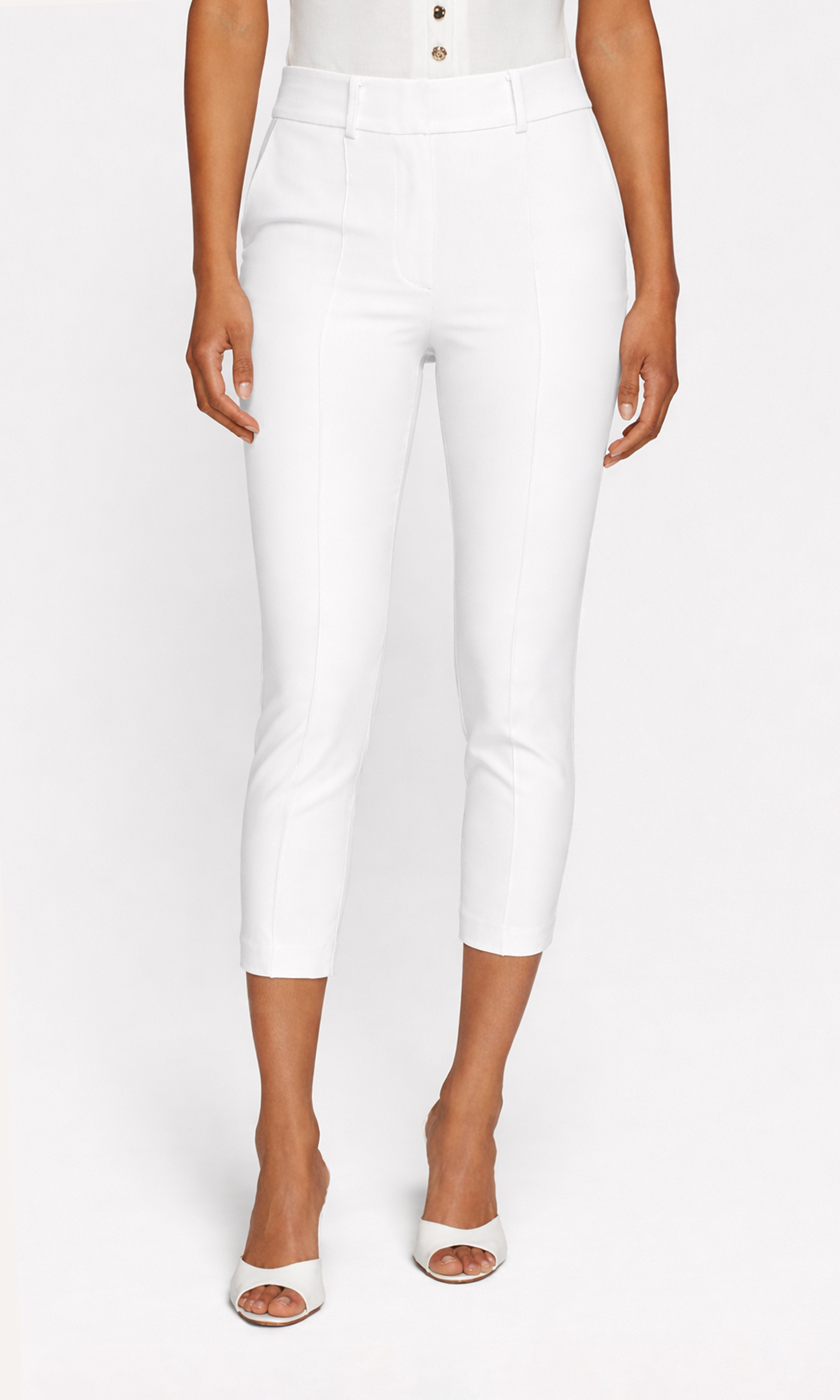 Person wearing white high-waisted pants on a white background