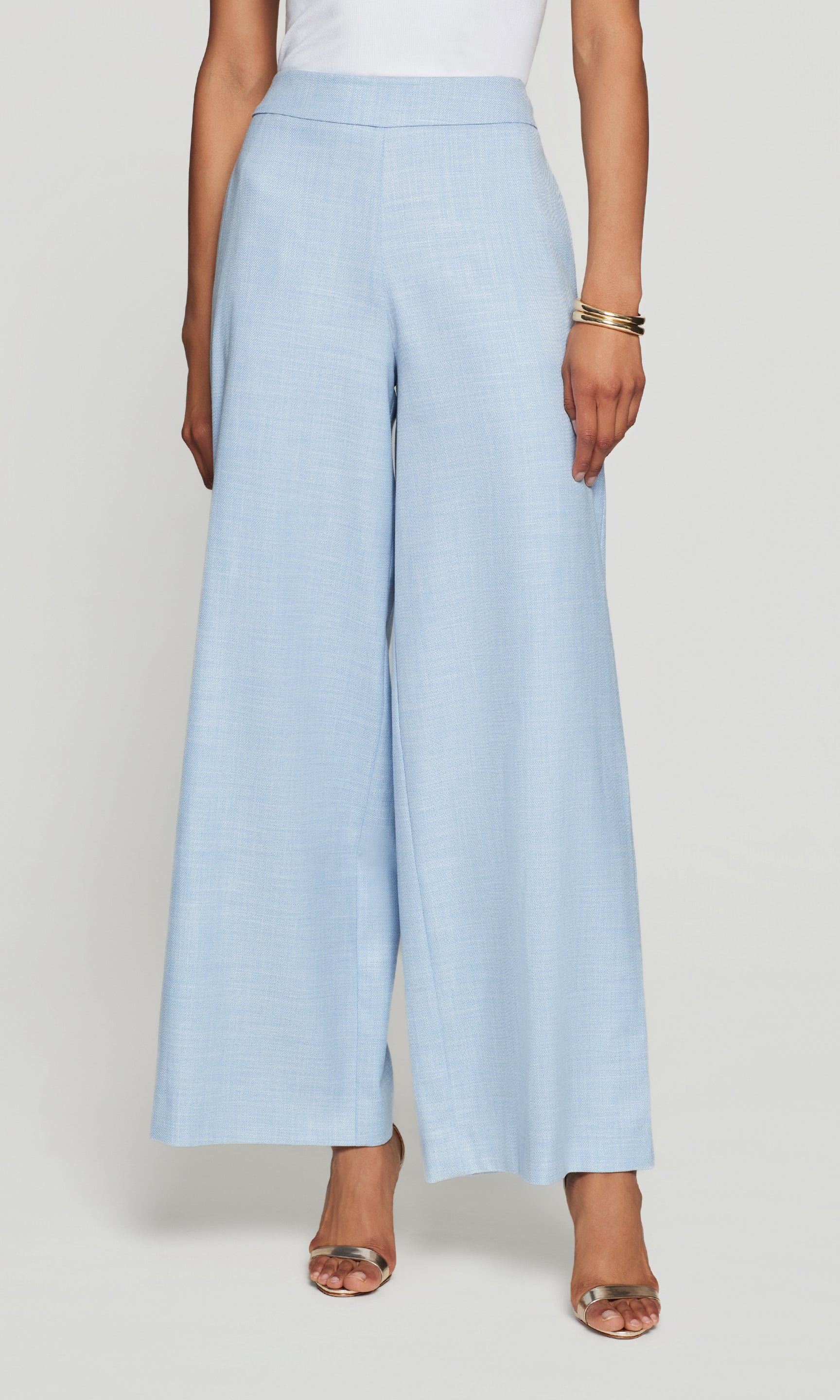 Magda Chambray Suiting Pants in chambray blue shown on the model in a front view crop from waist to hem.