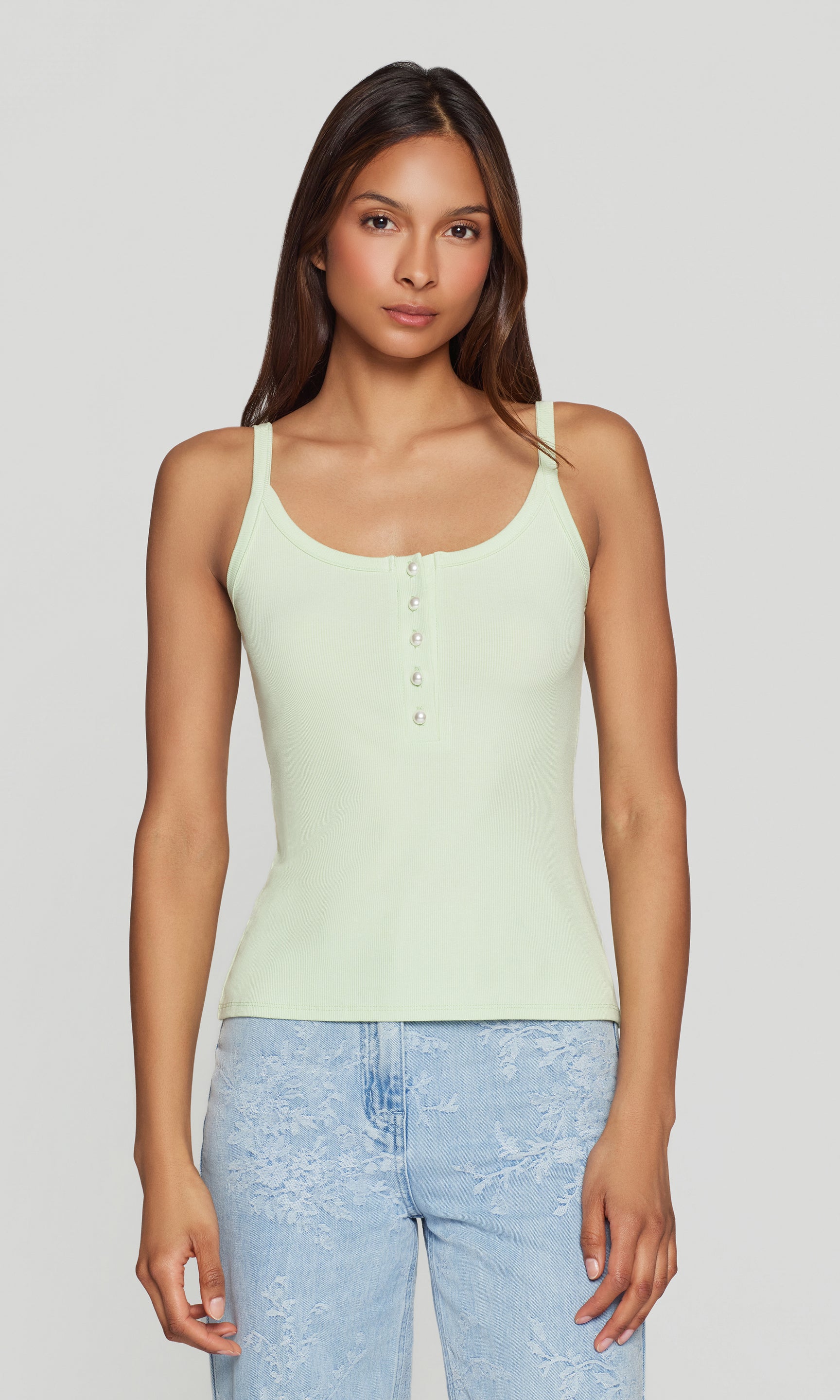The model wears the Molly Rib Tank Top in mint in a front view, highlighting the scoop neckline, button placket, and fitted rib-knit silhouette styled with denim.