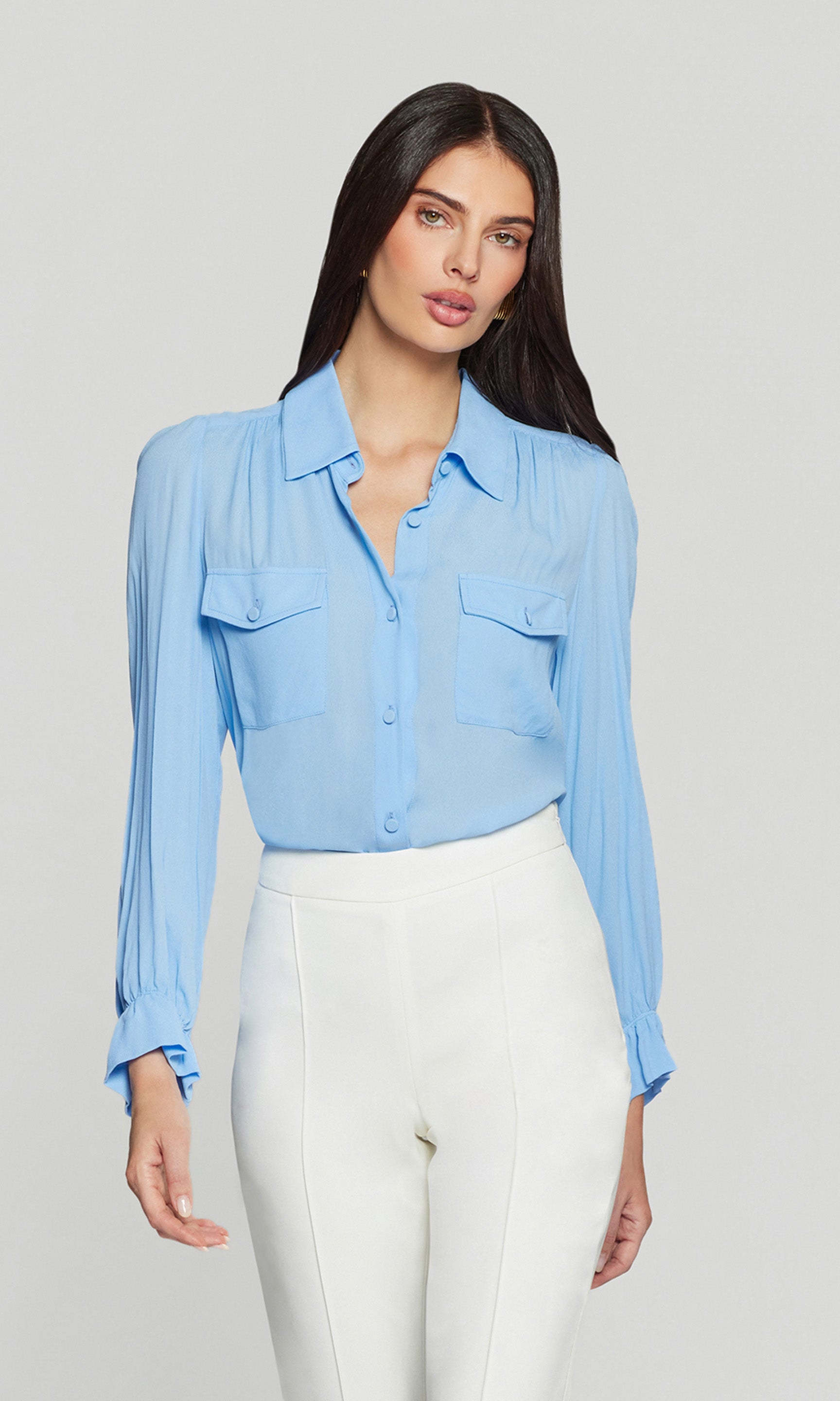 Model wears the Priya Georgette Shirt in light blue in a front view, showing the button placket, flap chest pockets, and easy long-sleeve silhouette