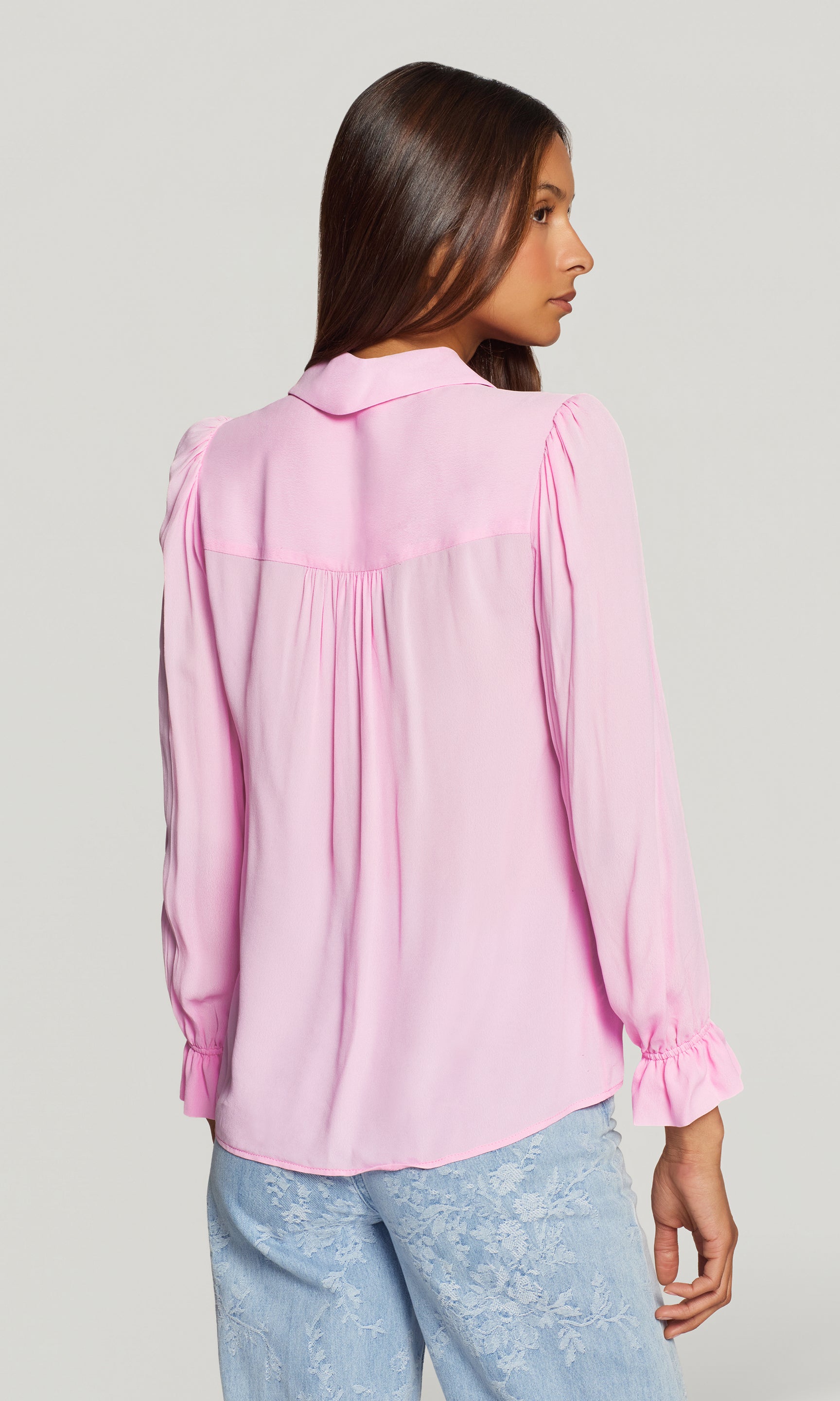 Model wears the Priya Georgette Shirt in soft rose in a back view, showing the drape through the shoulders and the lightweight flow of the fabric.