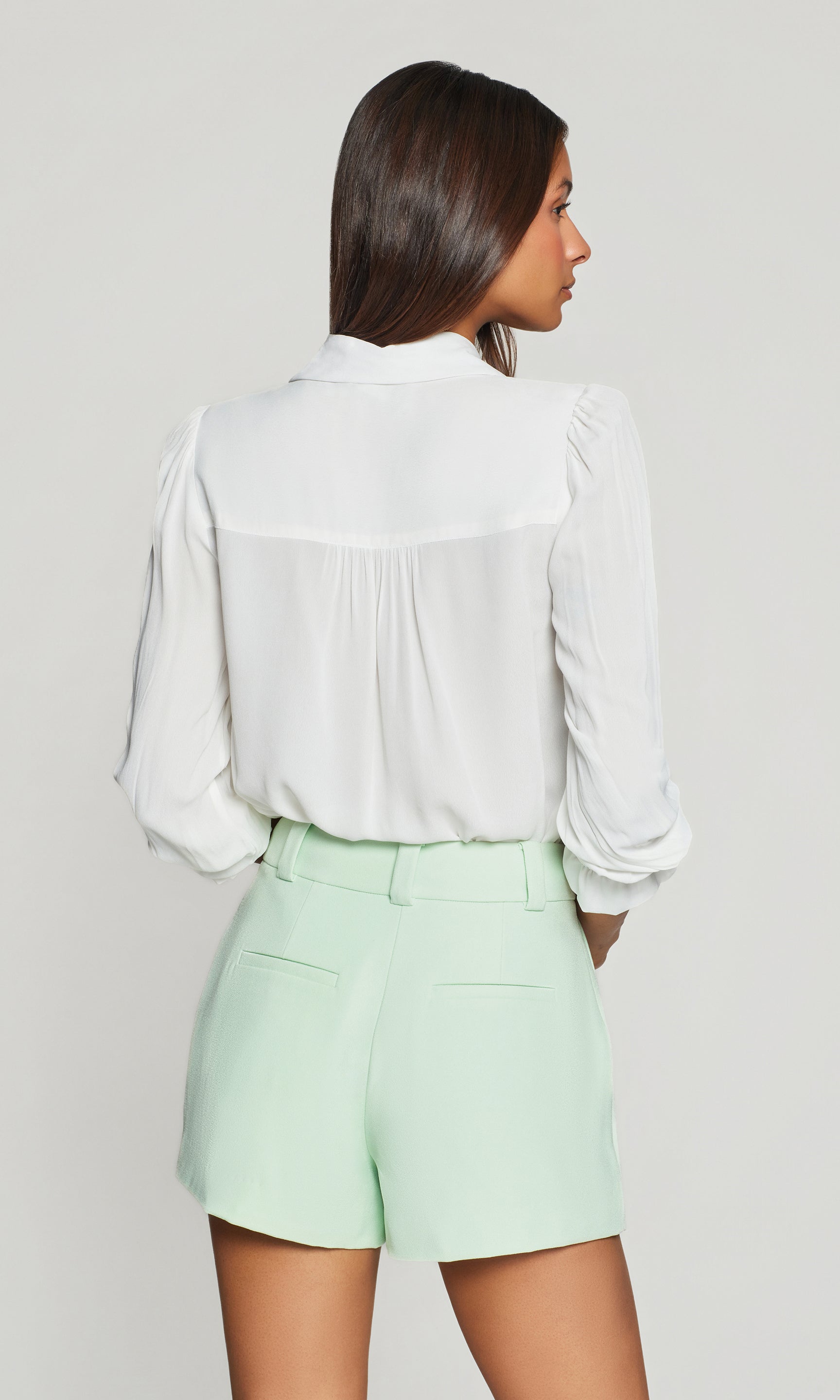 Model wears the Priya Georgette Shirt in white in a back view, highlighting the relaxed silhouette through the shoulders and the lightweight georgette flow