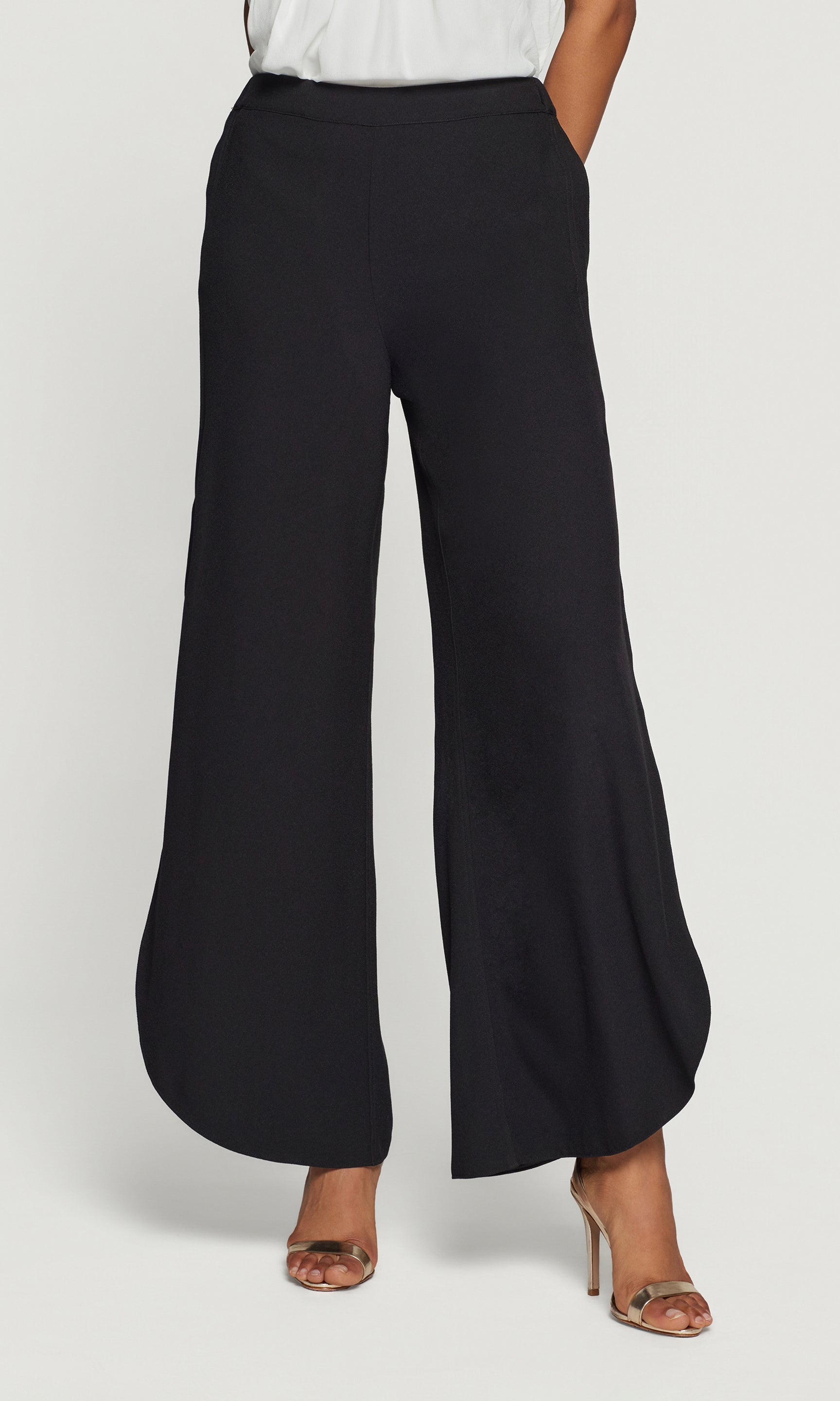 Black wide-leg pants worn by a person on a white background