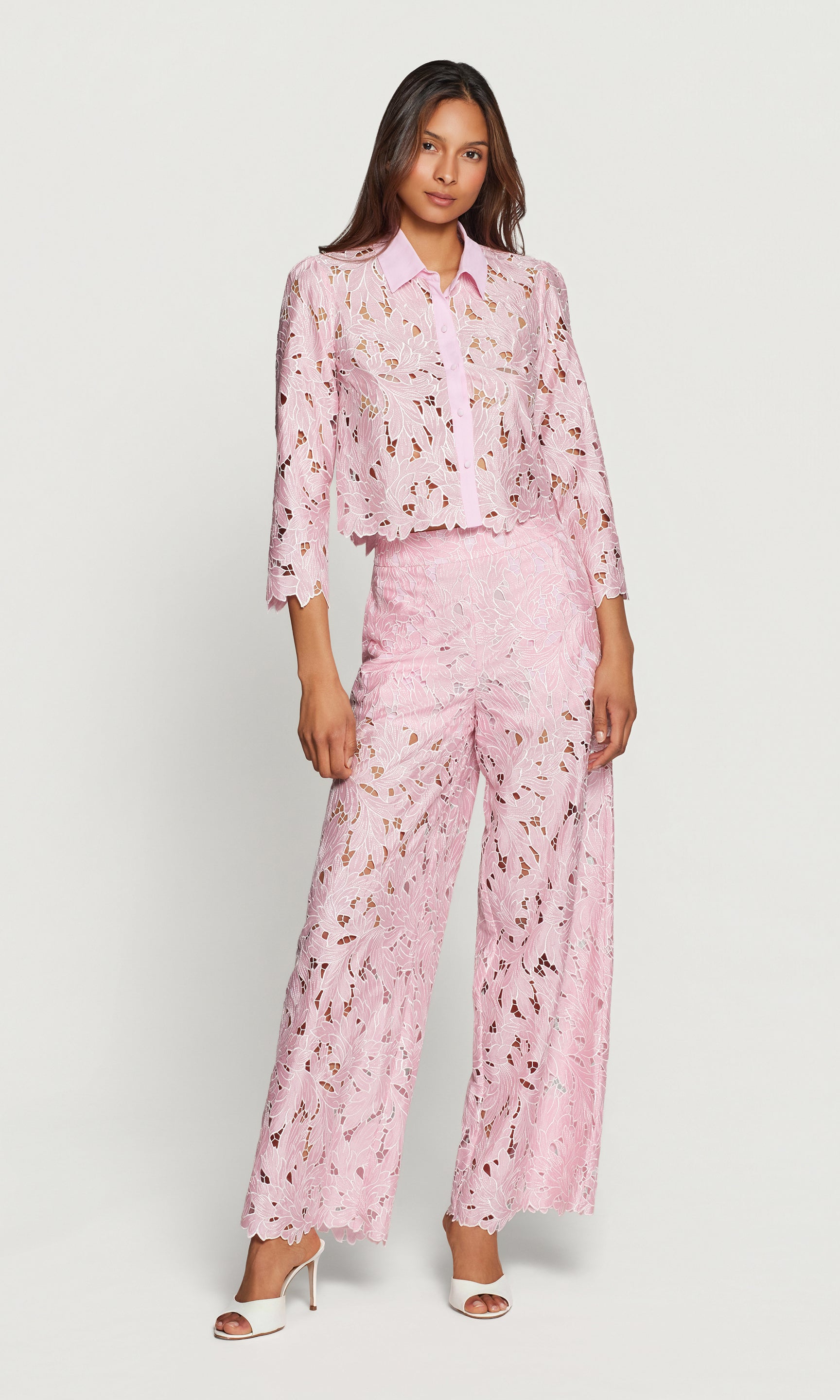 Woman wearing a pink floral outfit on a white background