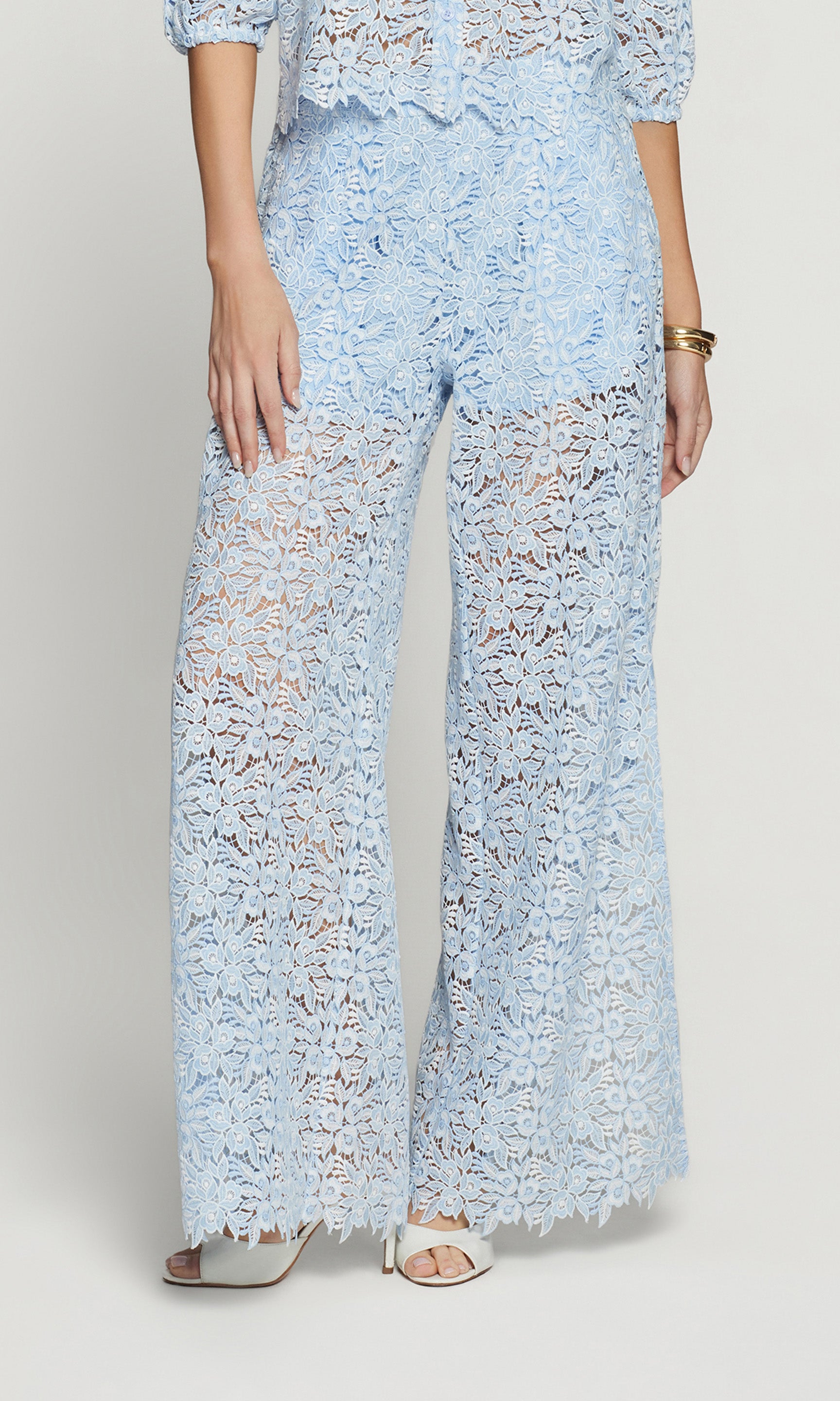 Light blue lace pants worn by a person on a plain background