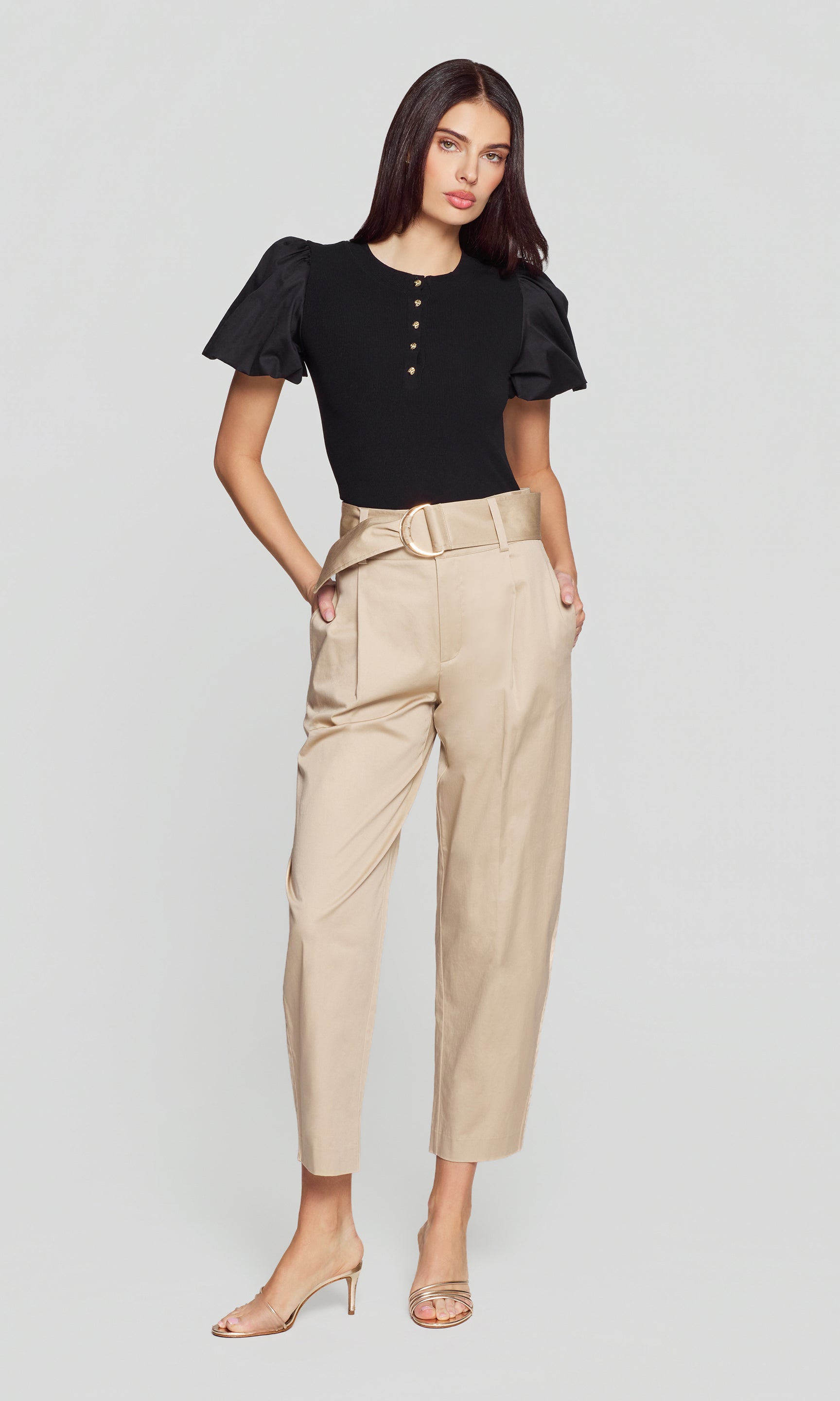 Model wears the Cassie Cotton Sateen Pants in light khaki in a full body front view, styled with a black top to show the complete silhouette.