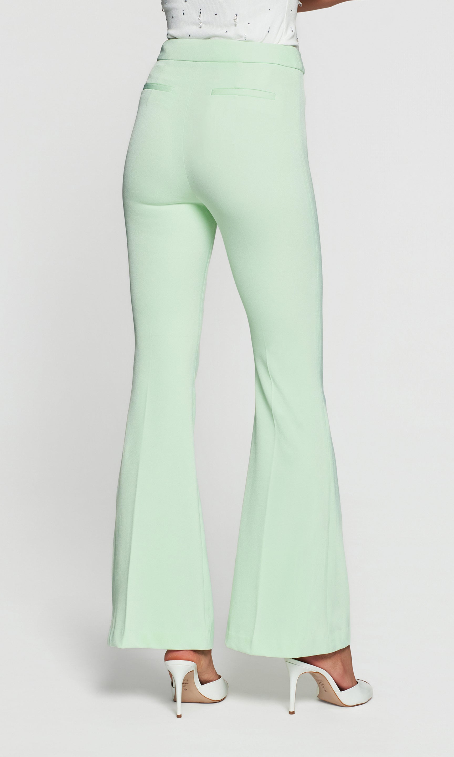 Model wears the Wesley Lightweight Crepe Pants in mint, close-up back detail view showing the back fit and flare shape as it falls cleanly toward the hem.