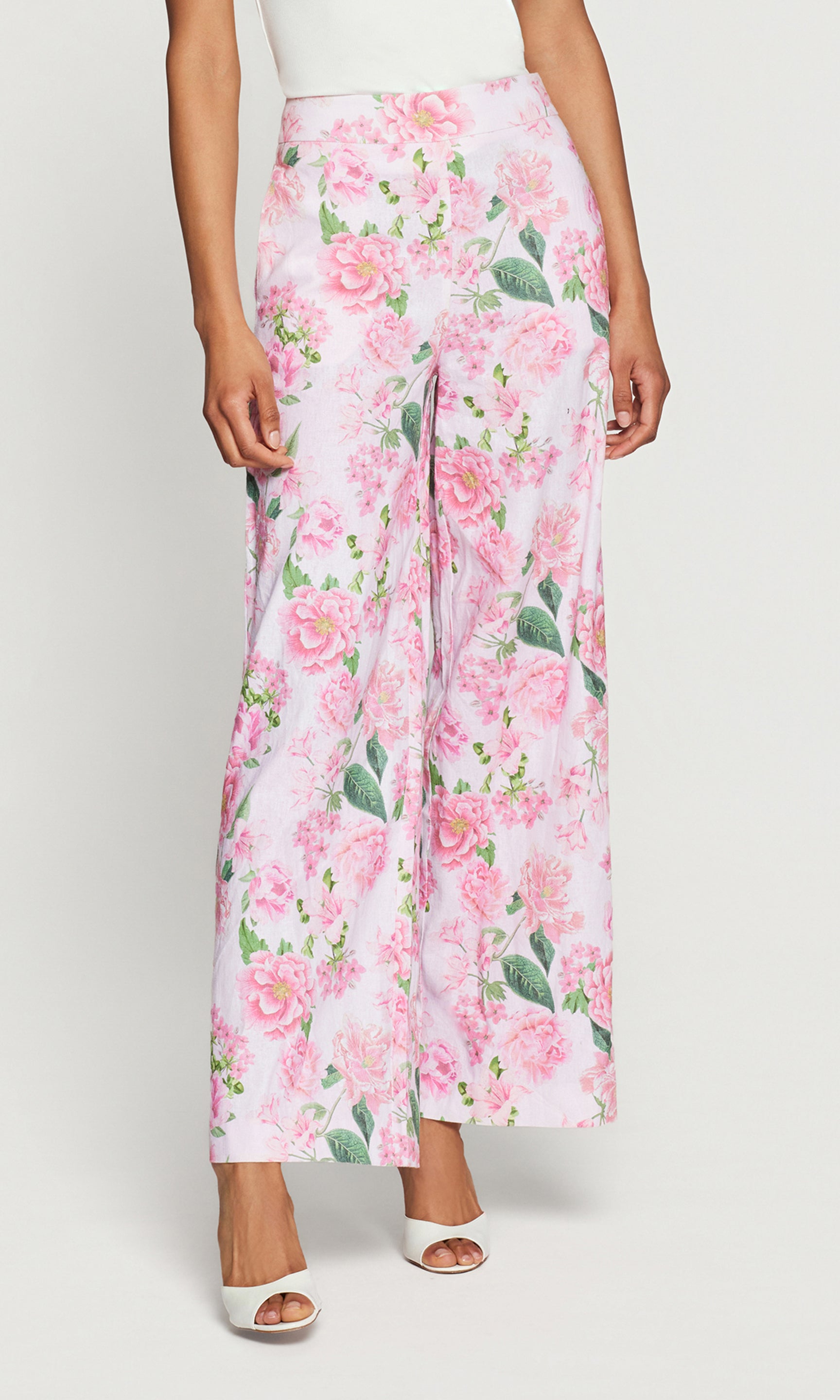 Floral pants with pink flowers and green leaves on a white background