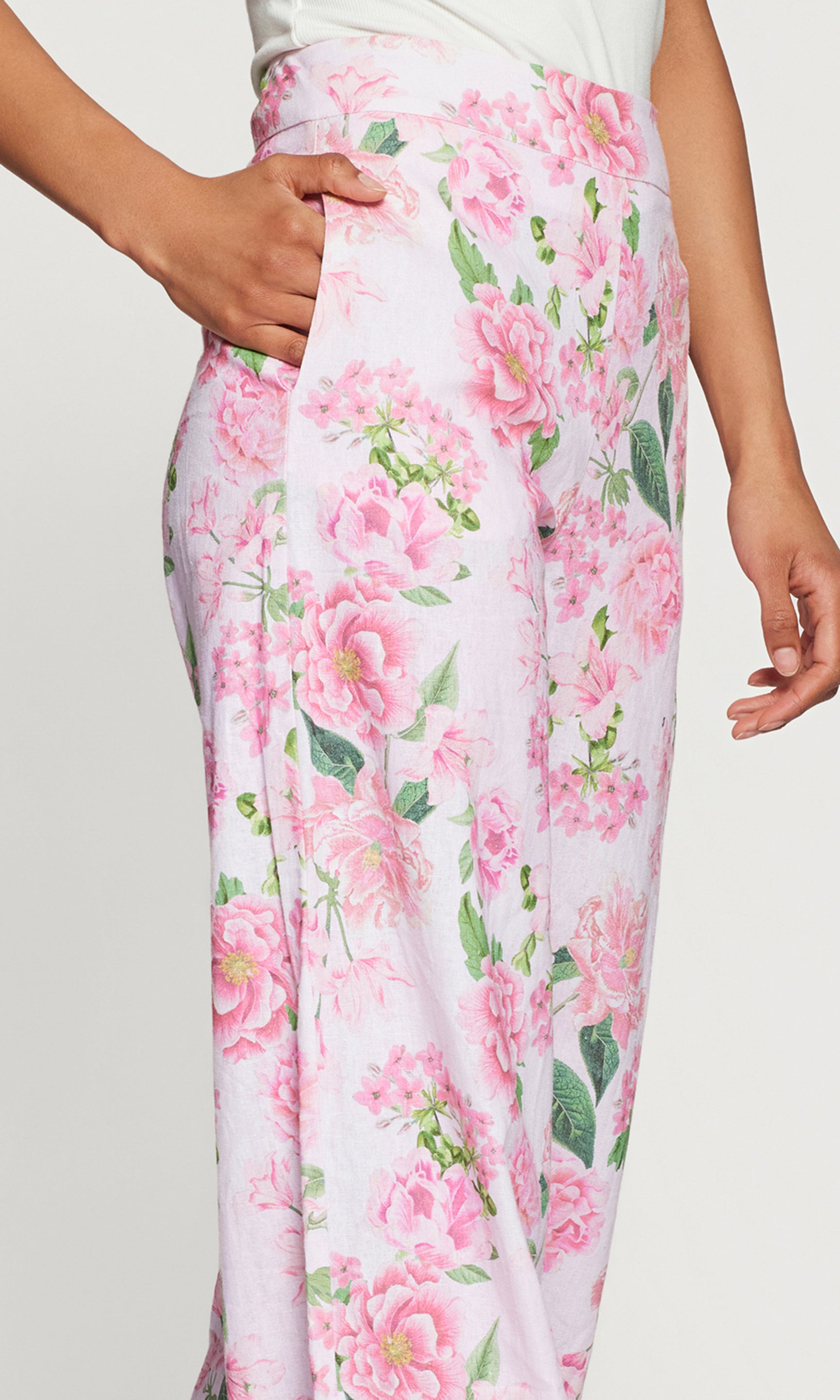 Close-up of floral pants with pink flowers on a white background