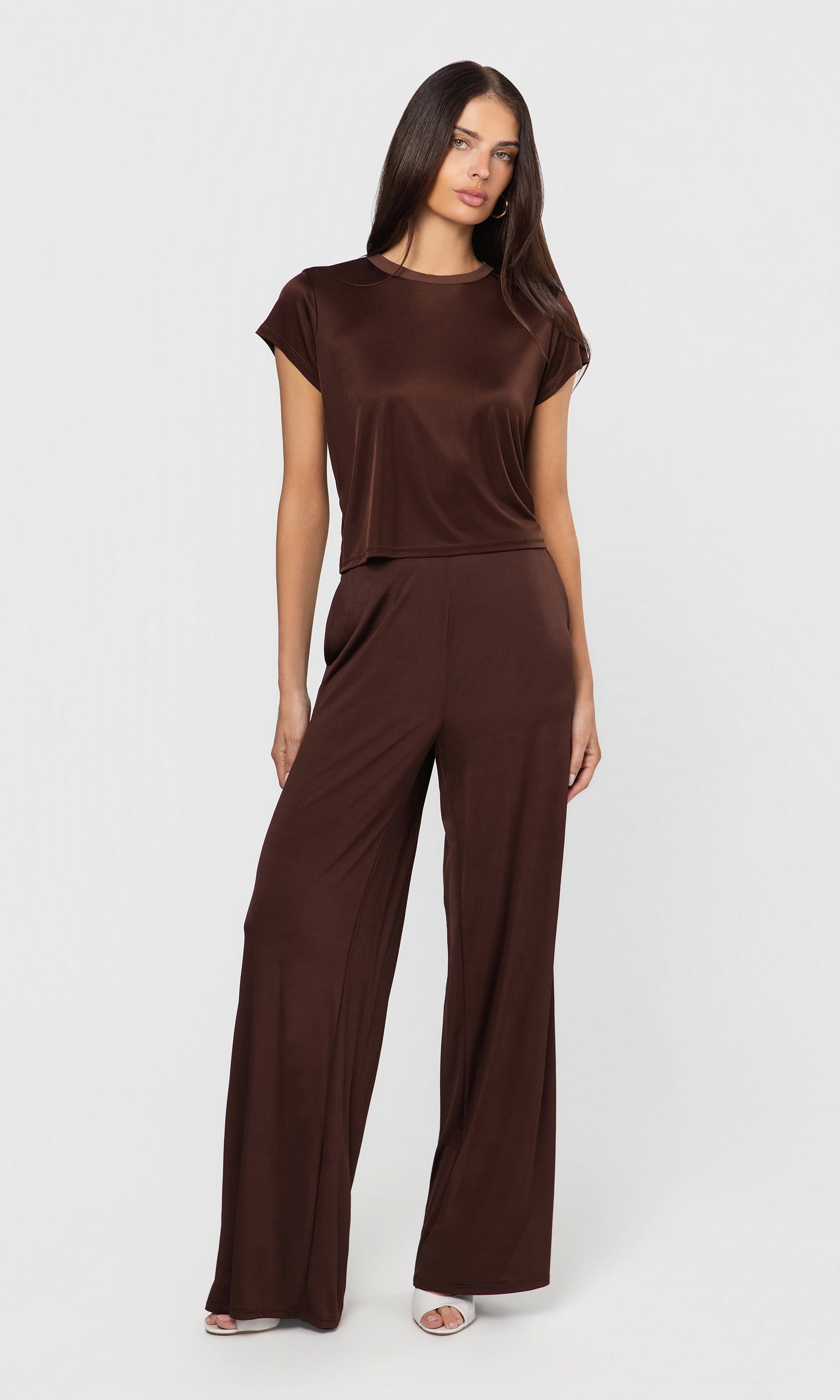 Woman wearing a brown outfit on a white background