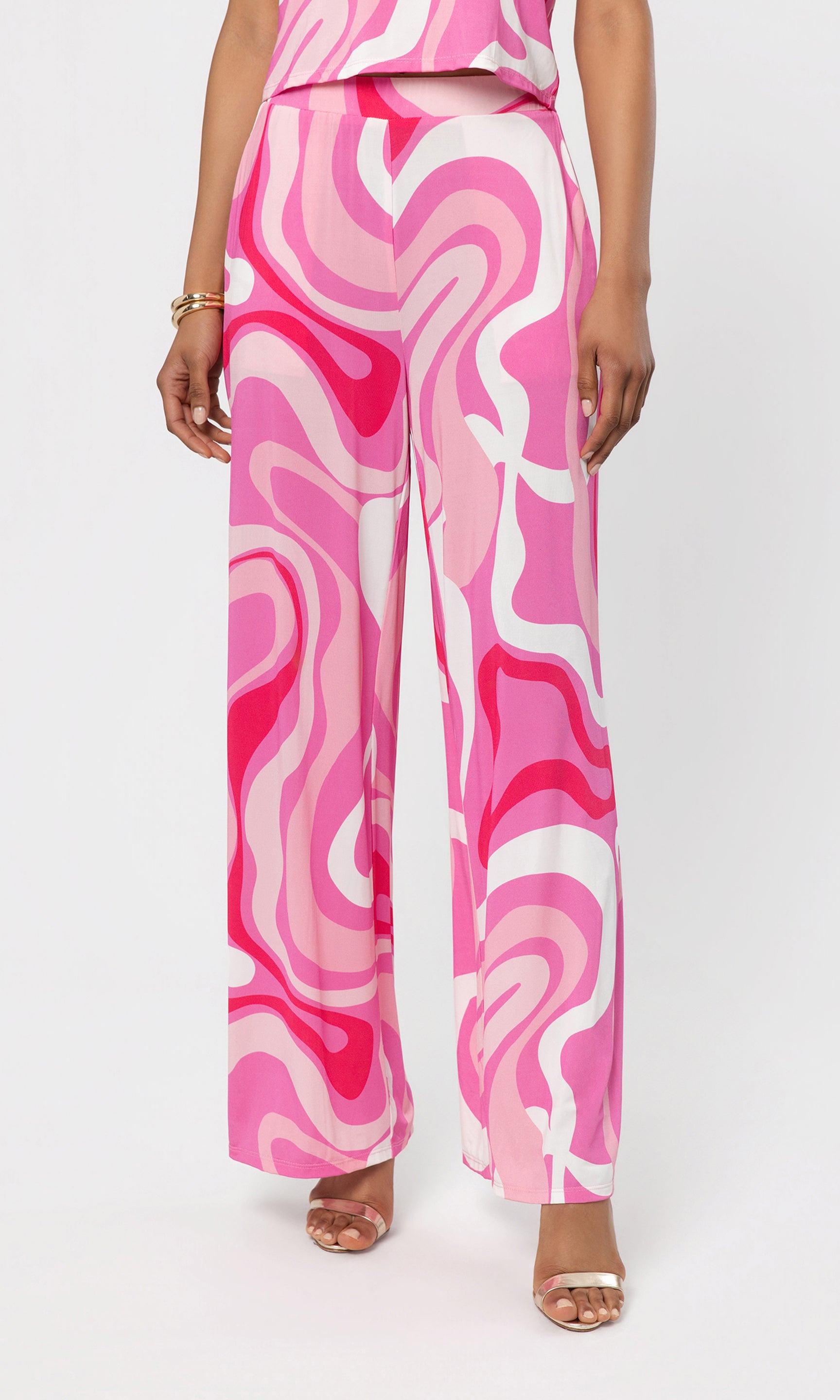Person wearing a pink and white patterned pant on a white background