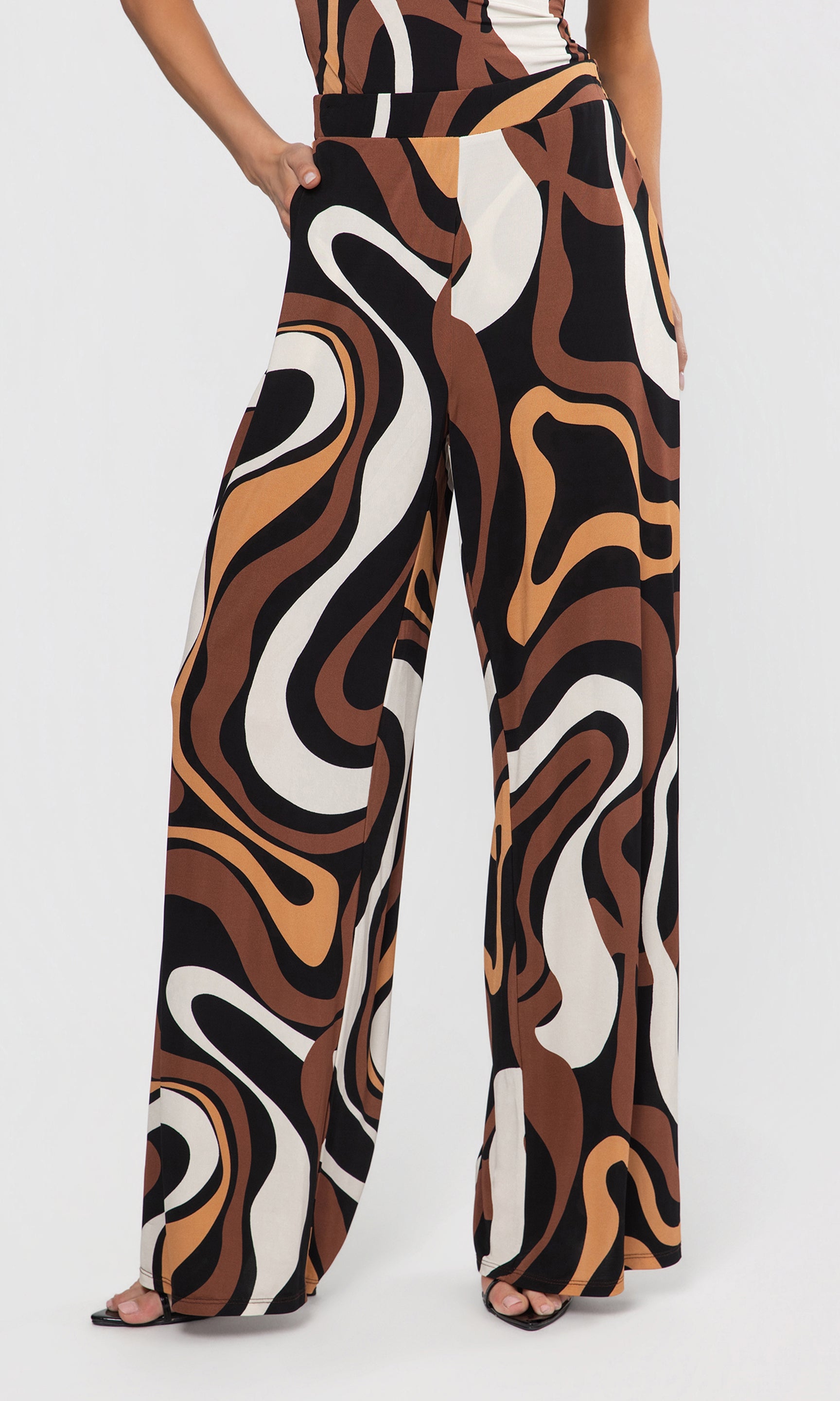 Patterned pants worn by a person on a white background