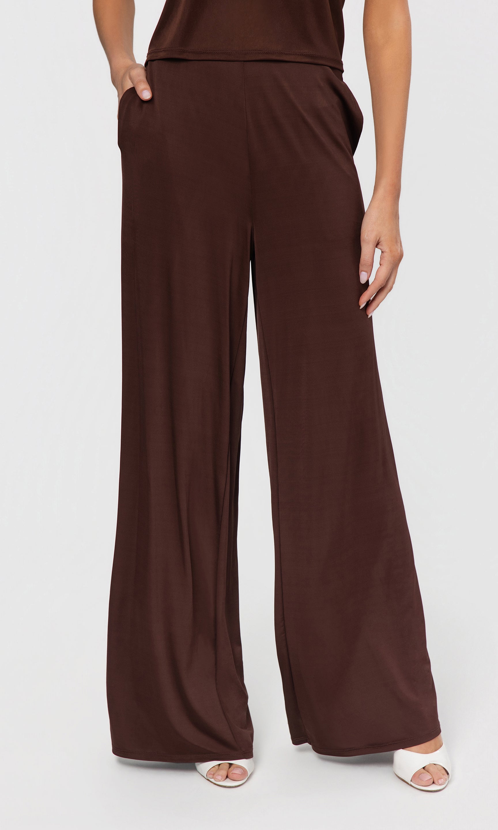 Brown wide-leg pants worn by a person on a white background