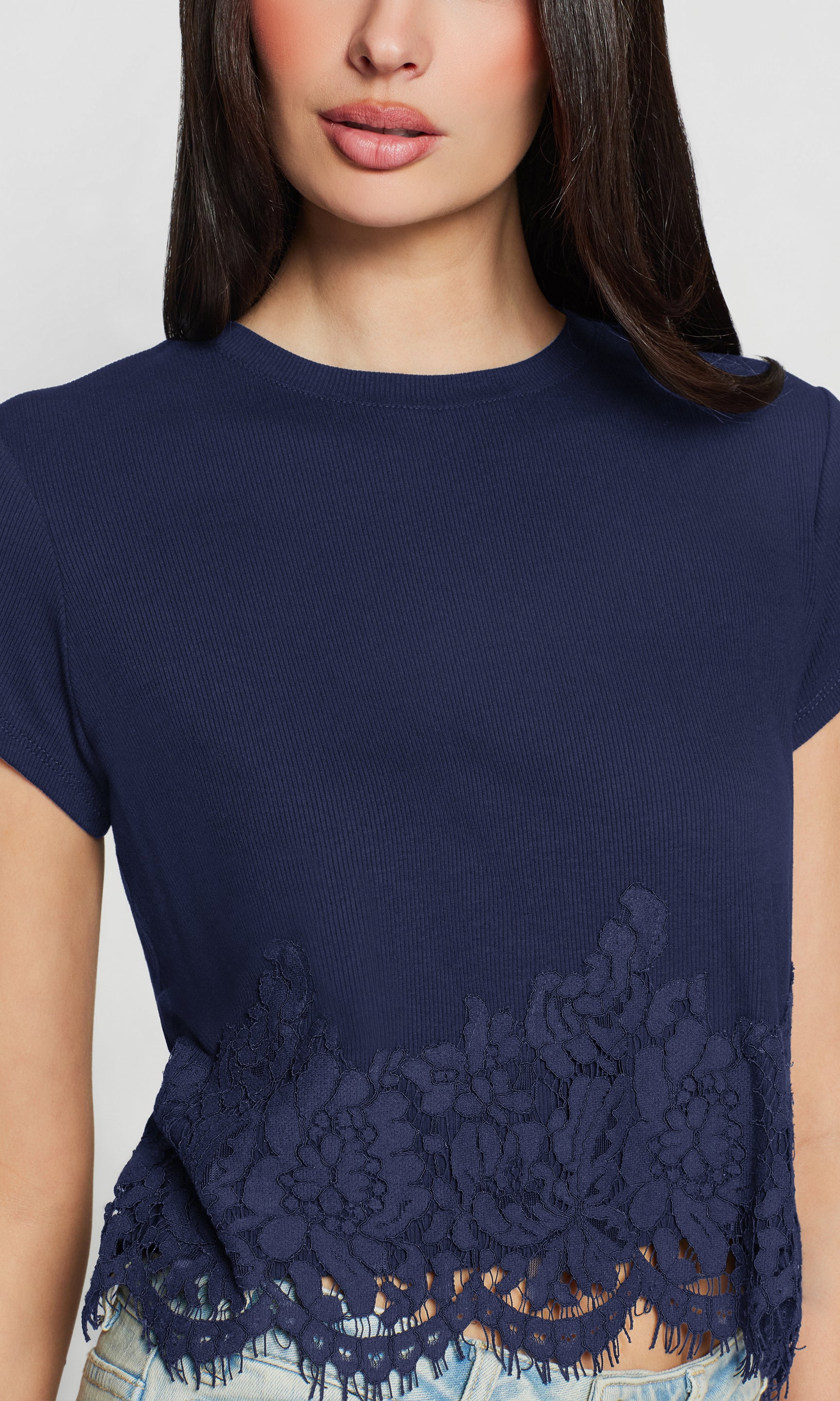 Navy blue t-shirt with lace detailing on a plain background