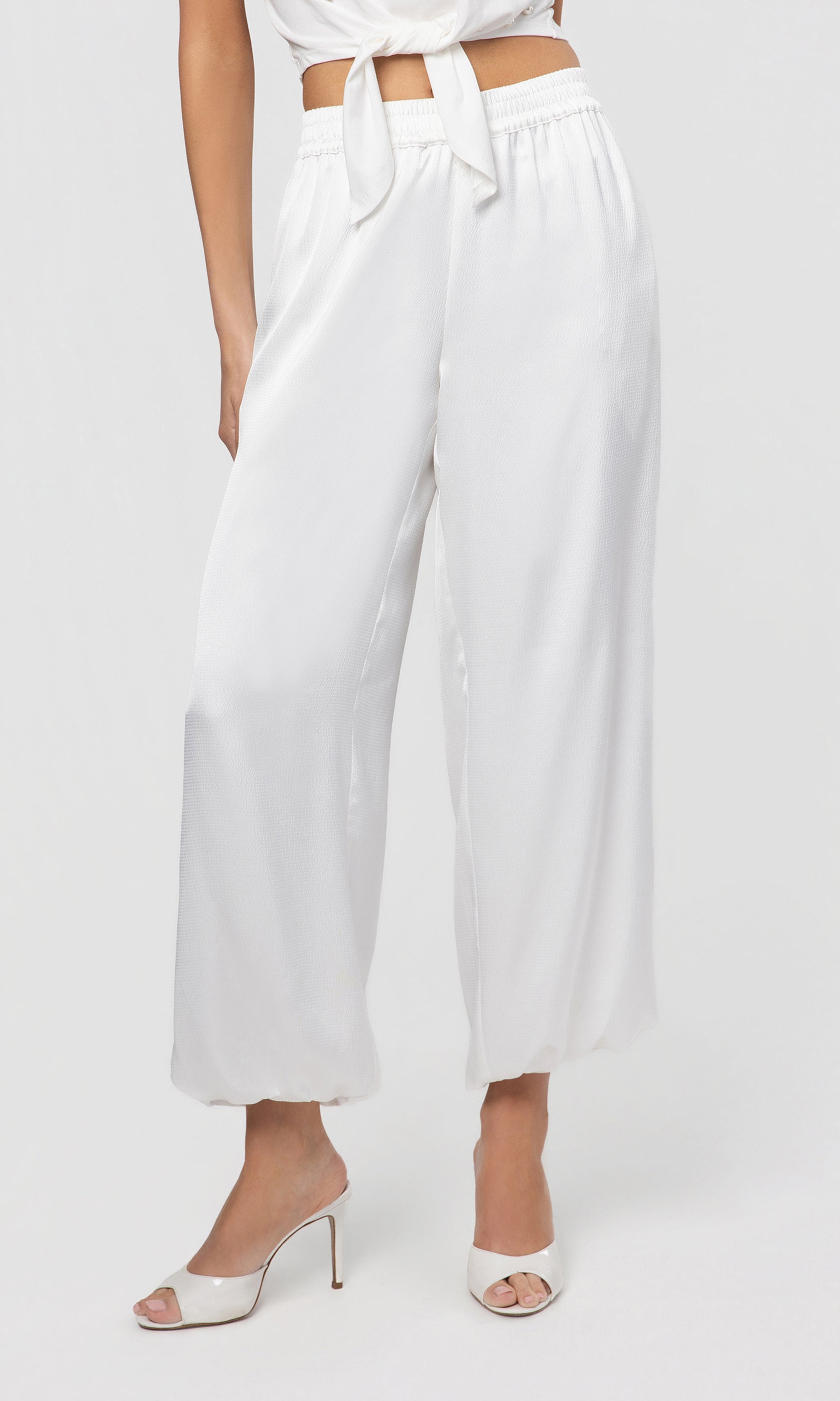 White wide-leg pants worn by a person on a white background