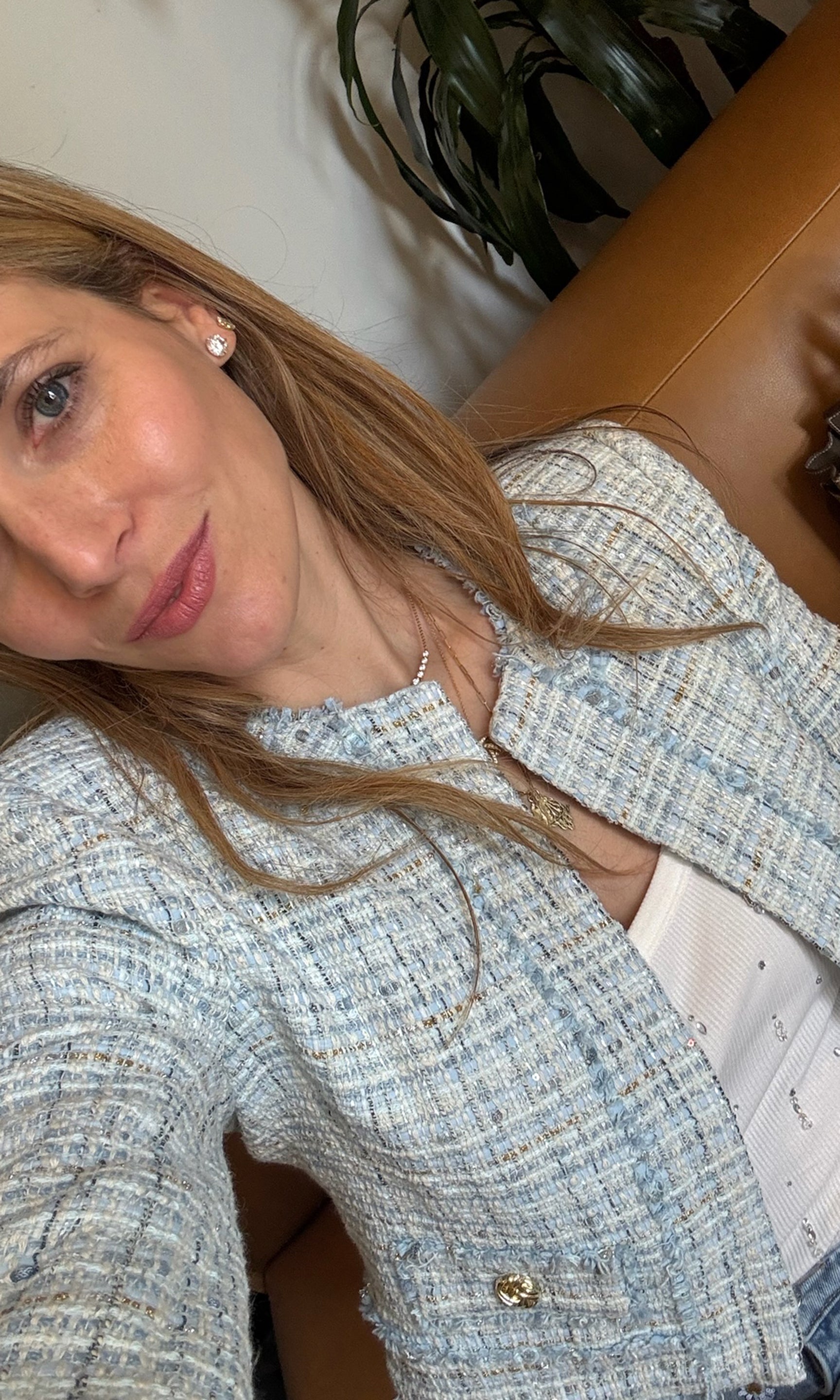 Our founder Roni wearing a blue textured tweed blazer in an indoor setting