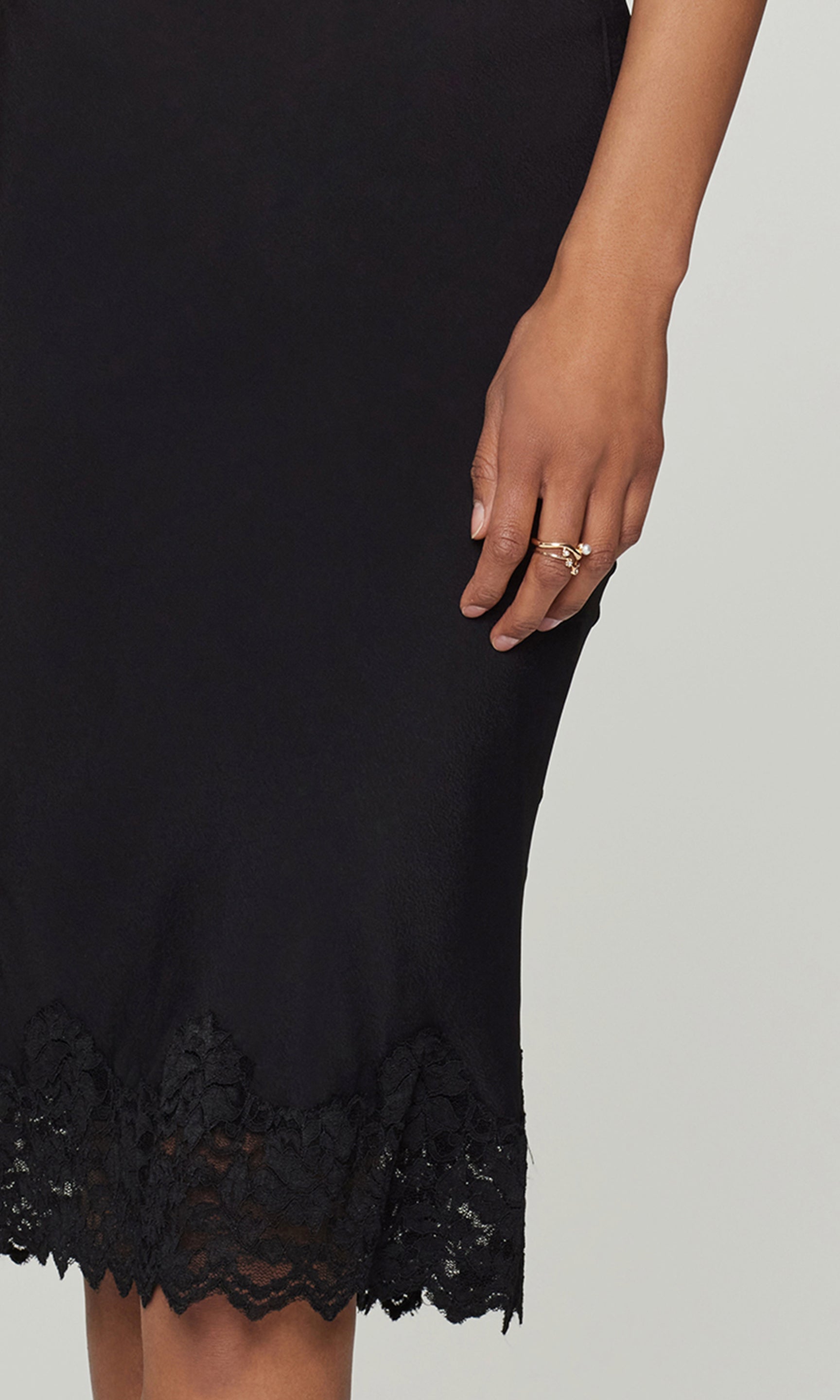 Close-up of black skirt with a lace hem