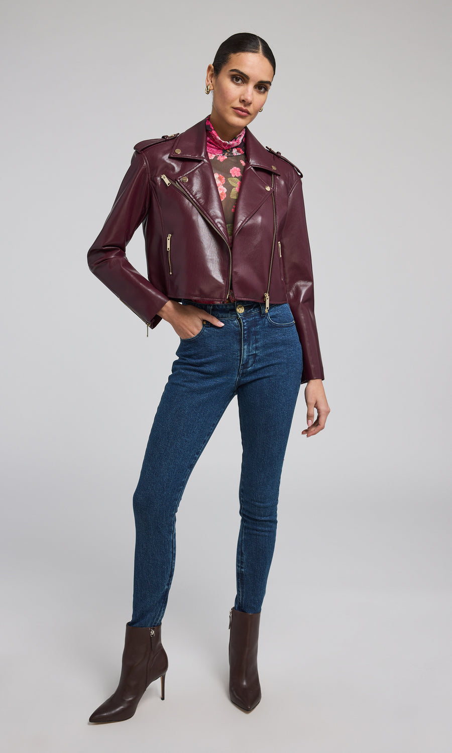 A chic burgundy leather jacket, exuding sophistication and versatility, ideal for various occasions and styles.