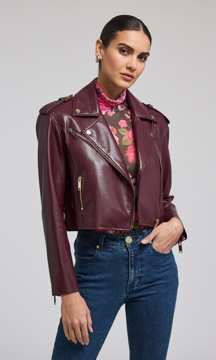 A chic burgundy leather jacket, exuding sophistication and versatility, ideal for various occasions and styles.