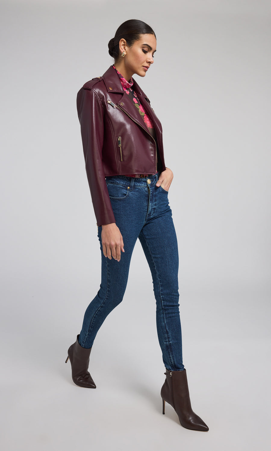 A chic burgundy leather jacket, exuding sophistication and versatility, ideal for various occasions and styles.