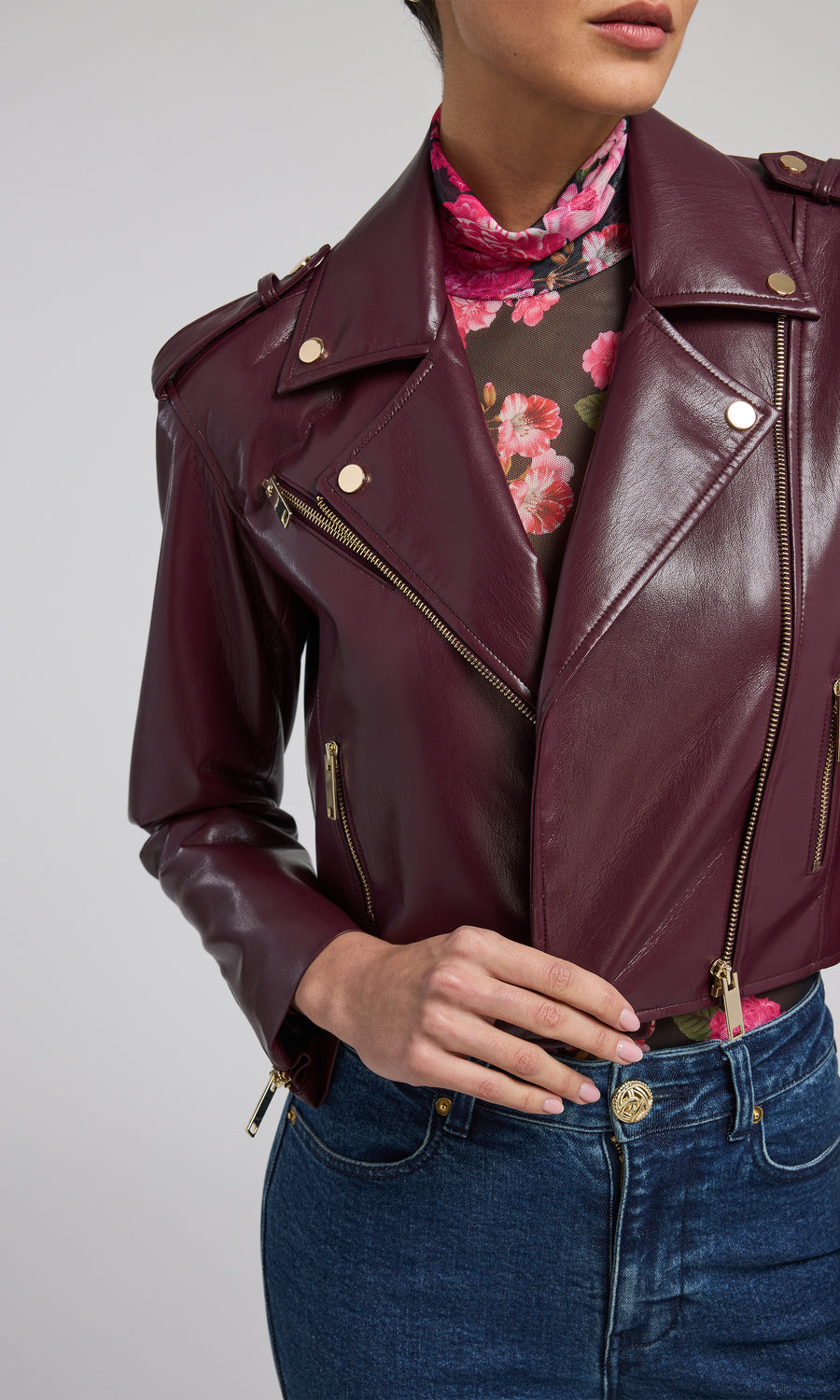 A chic burgundy leather jacket, exuding sophistication and versatility, ideal for various occasions and styles.