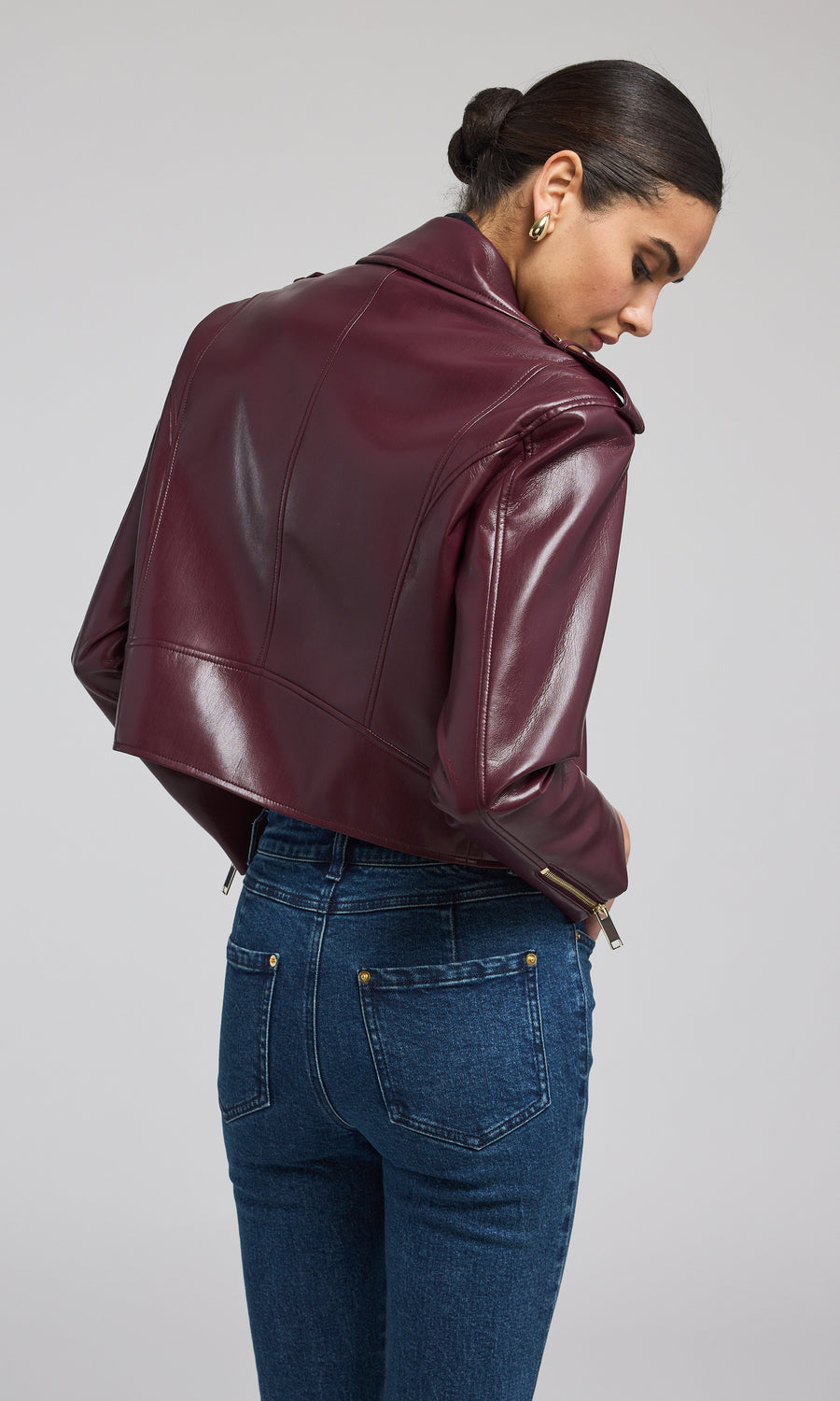 A chic burgundy leather jacket, exuding sophistication and versatility, ideal for various occasions and styles.