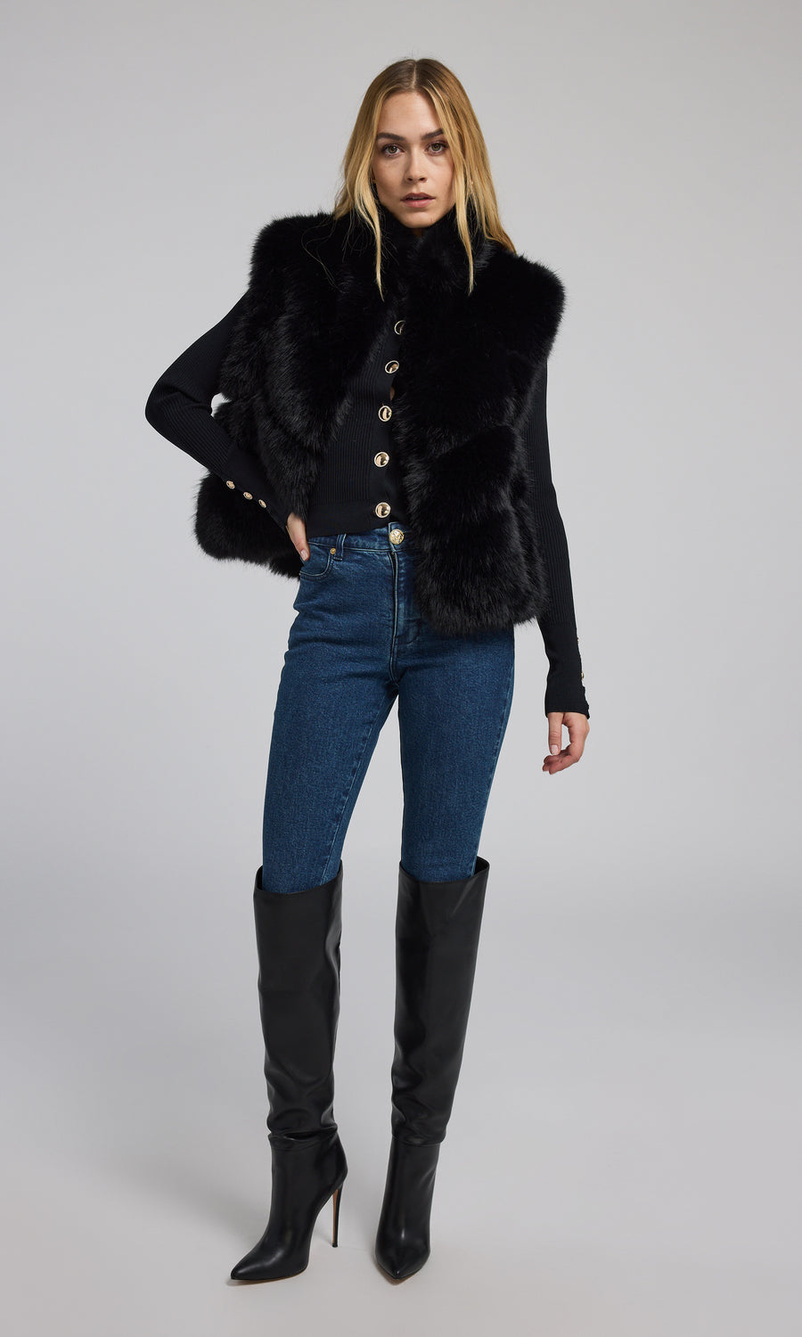 A fashionable black faux fur vest, designed for warmth and style, ideal for enhancing any ensemble with its plush texture.