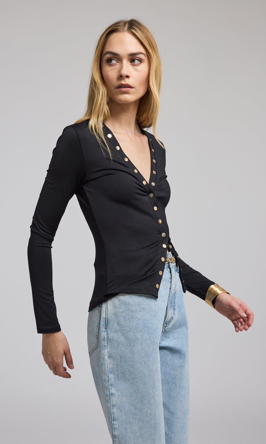 The model is dressed in a chic black top, emphasizing its modern style and sophistication.