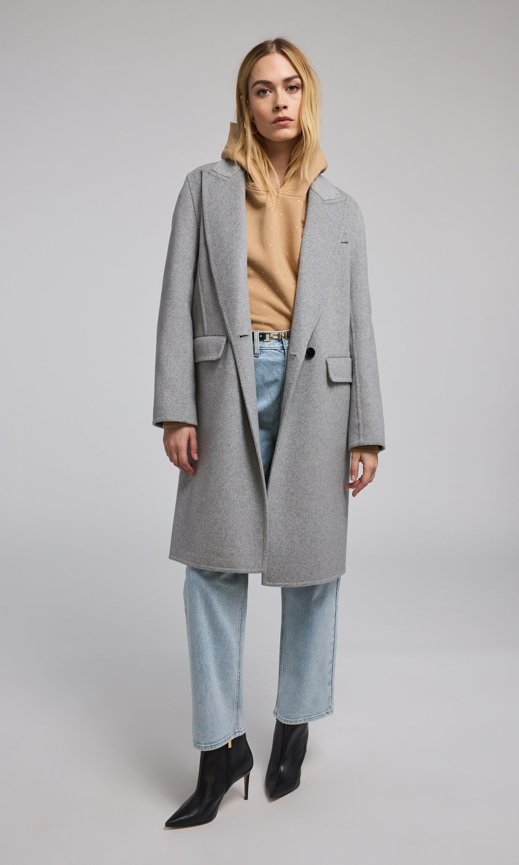 A light grey wool coat, elegantly designed, showcasing its soft texture and sophisticated style. 