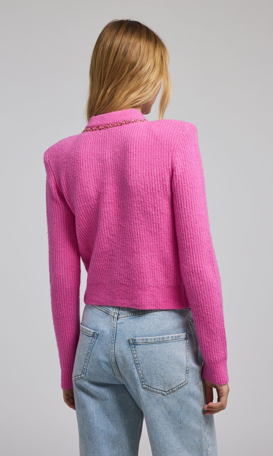 A pink chain cardigan featuring a buttoned front, showcasing a stylish and cozy design suitable for various occasions.