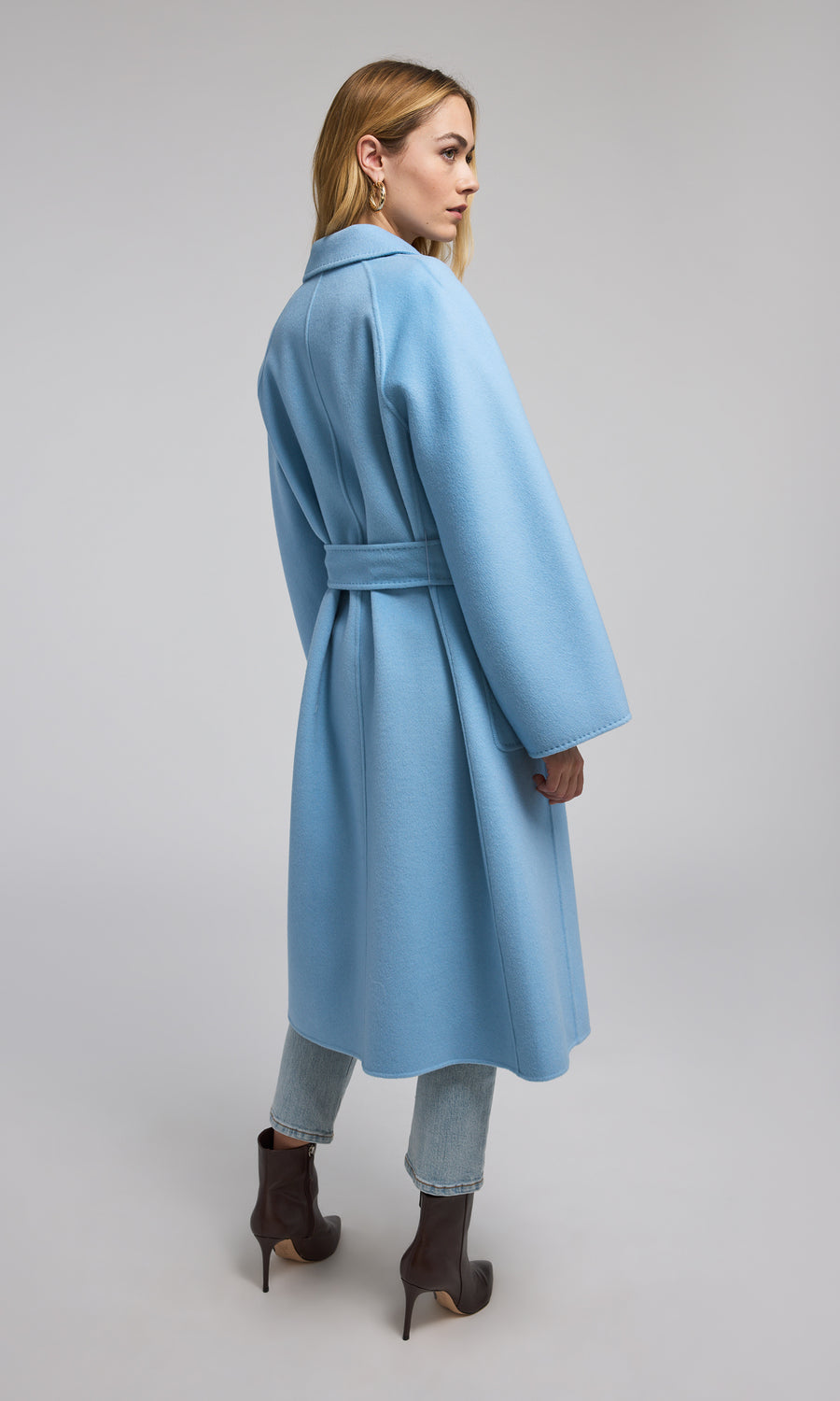 A fashionable blue wool coat adorned with a belt, perfect for adding a touch of style and warmth to any outfit.