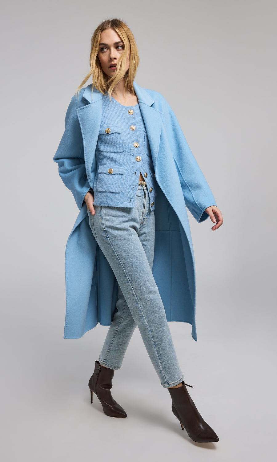 A fashionable blue wool coat adorned with a belt, perfect for adding a touch of style and warmth to any outfit.