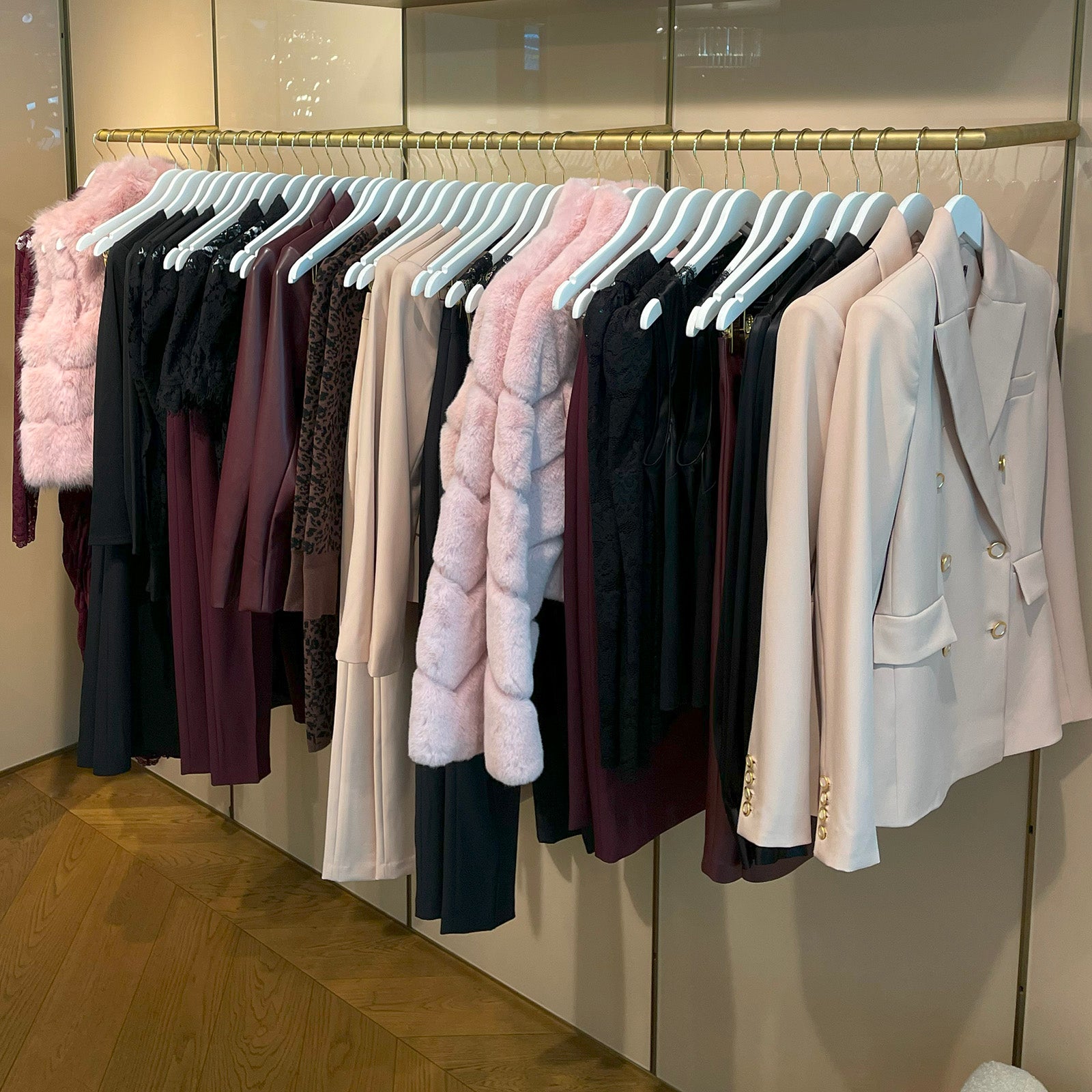 Clothing rack with various Generation Love fall faux fur jackets and coats in a store setting
