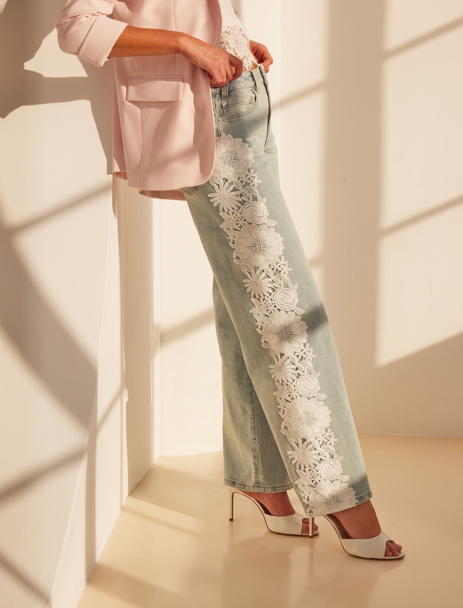 Indoor shot of the Jethro Lace Combo Denim Jeans styled with heels