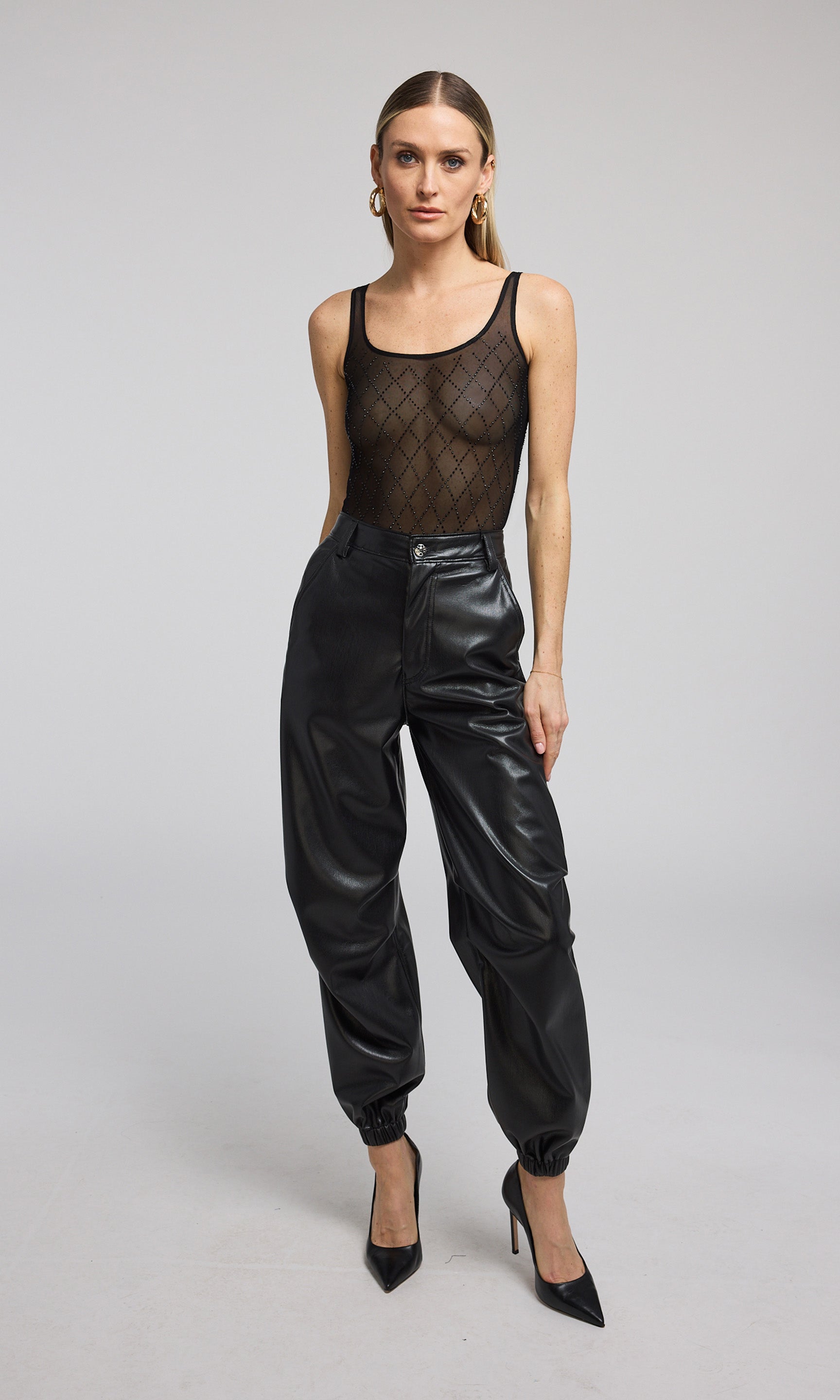 A stylish black crystal mesh bodysuit, exemplifying modern fashion and allure.