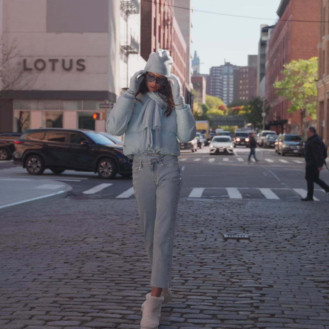 two models in a city street showing off different colored ski outfits