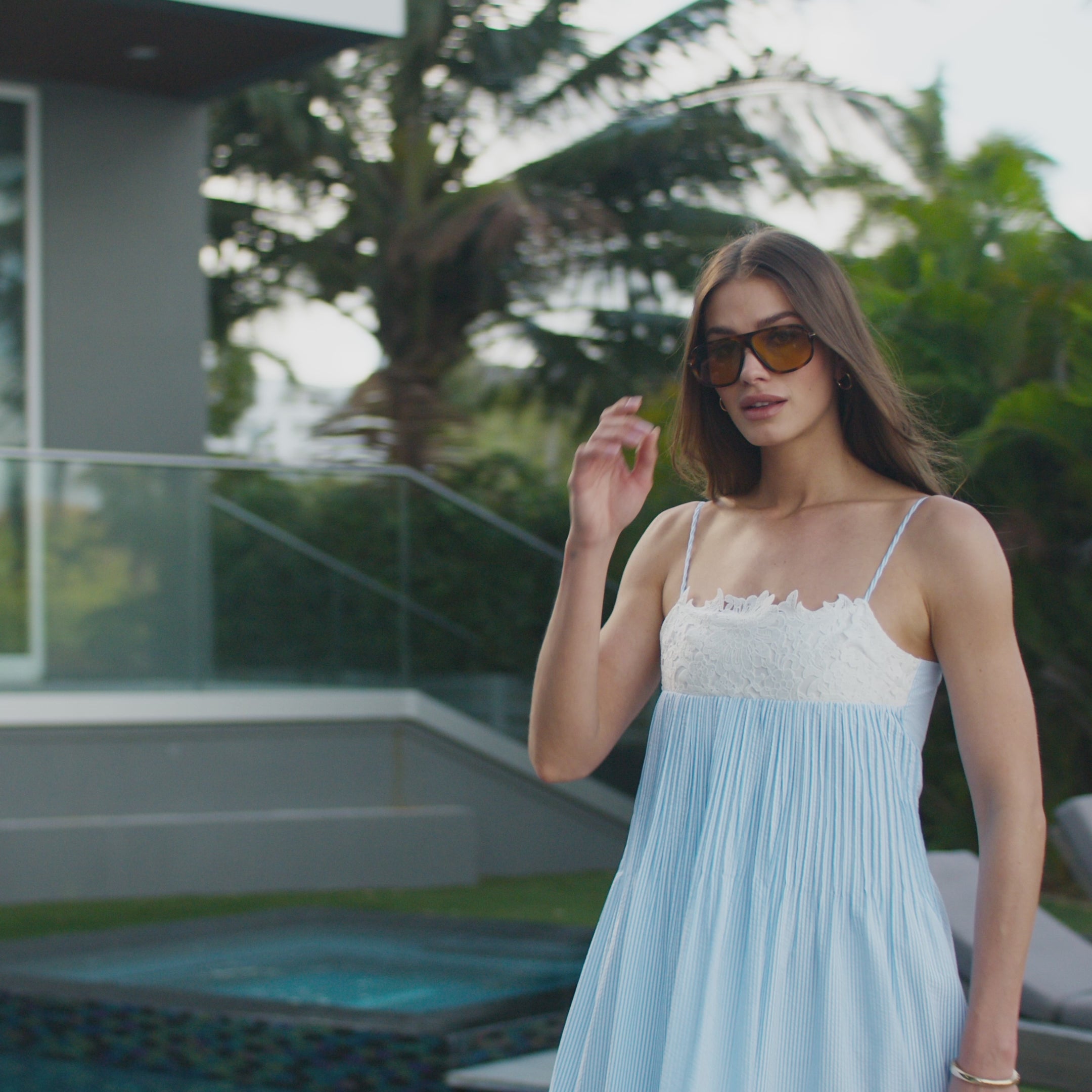 montage video of models wearing white and blue summer outfits: dresses, tops, pants and skirts