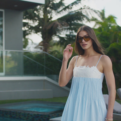 montage video of models wearing white and blue summer outfits: dresses, tops, pants and skirts