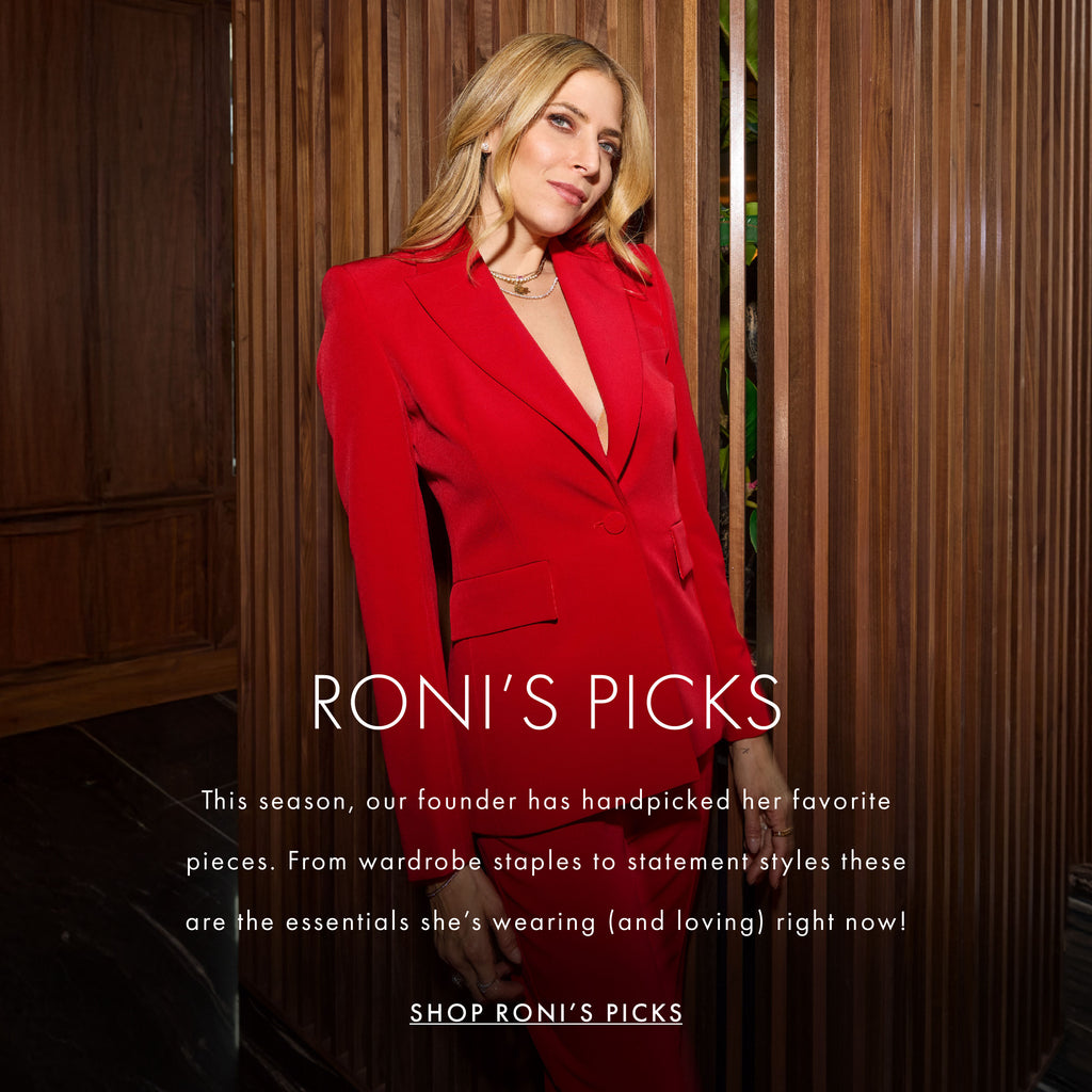 Founder Roni Hirshberg wheres a red satin suit from generation love's holiday 2024 collection