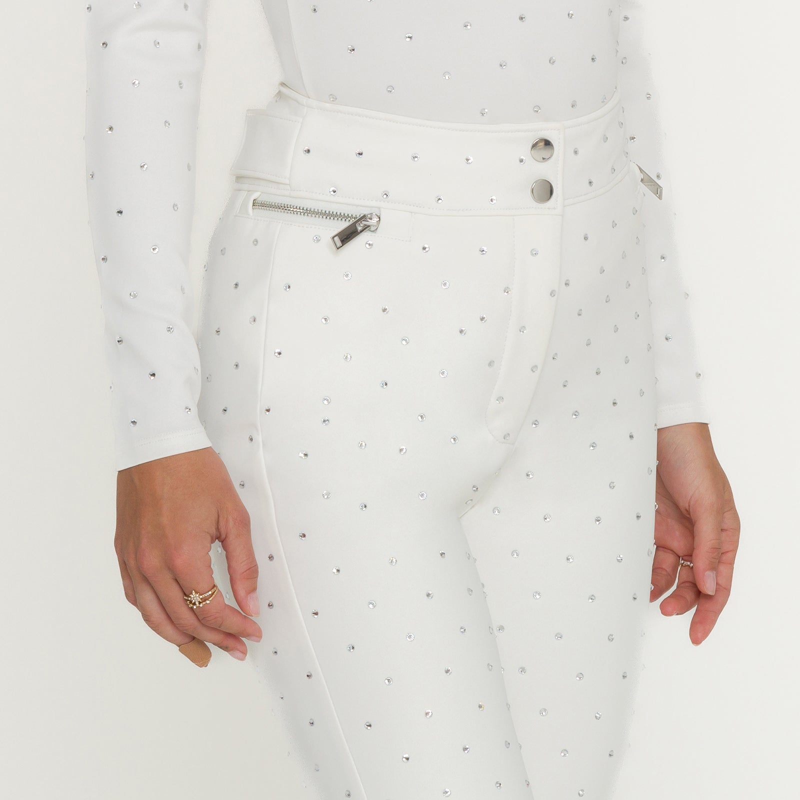 White outfit with crystals on a plain background
